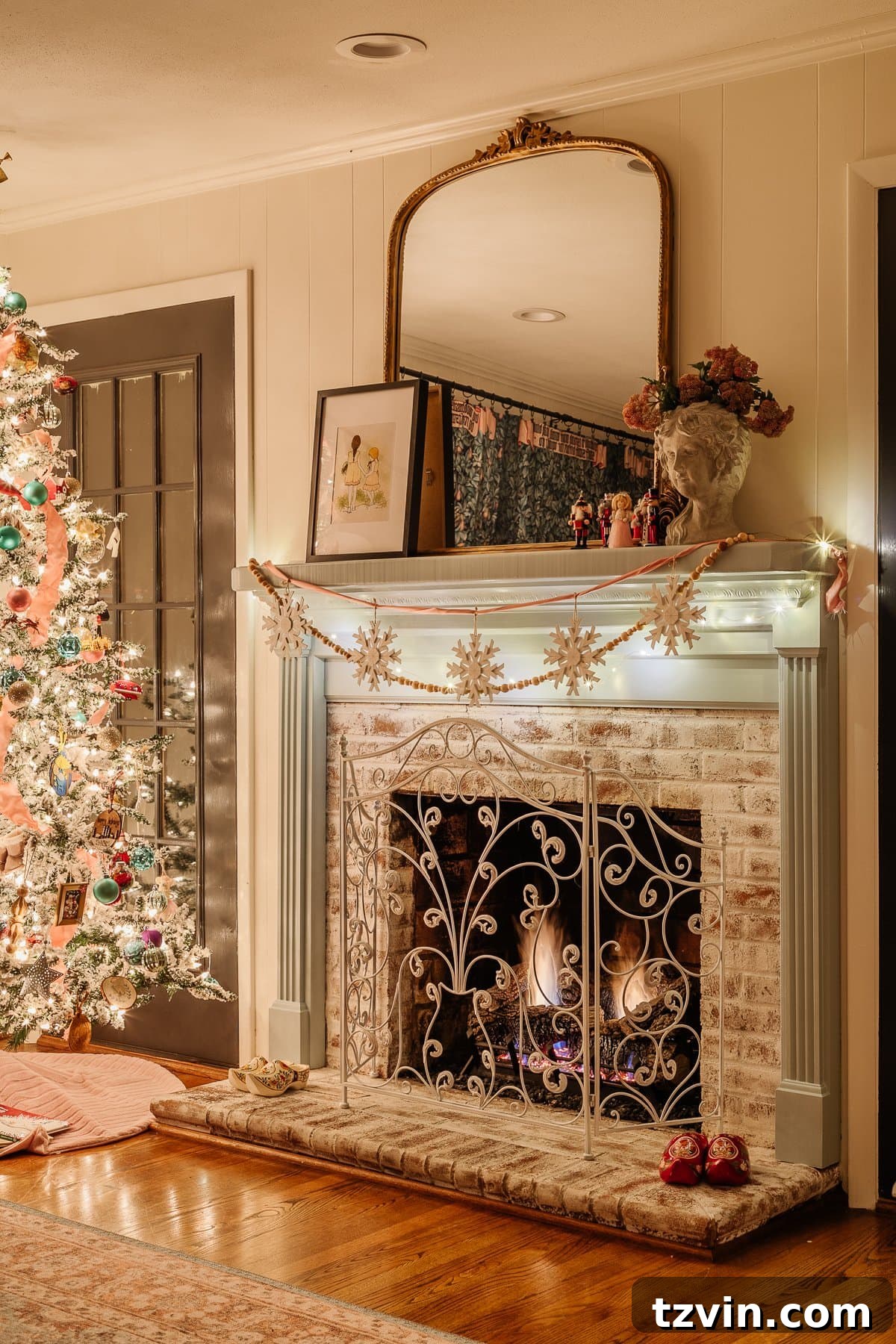 Holiday Glow Home Showcase 19 The Christmas playroom featuring a beautifully decorated mantel and a sparkling tree, creating a festive atmosphere at night.