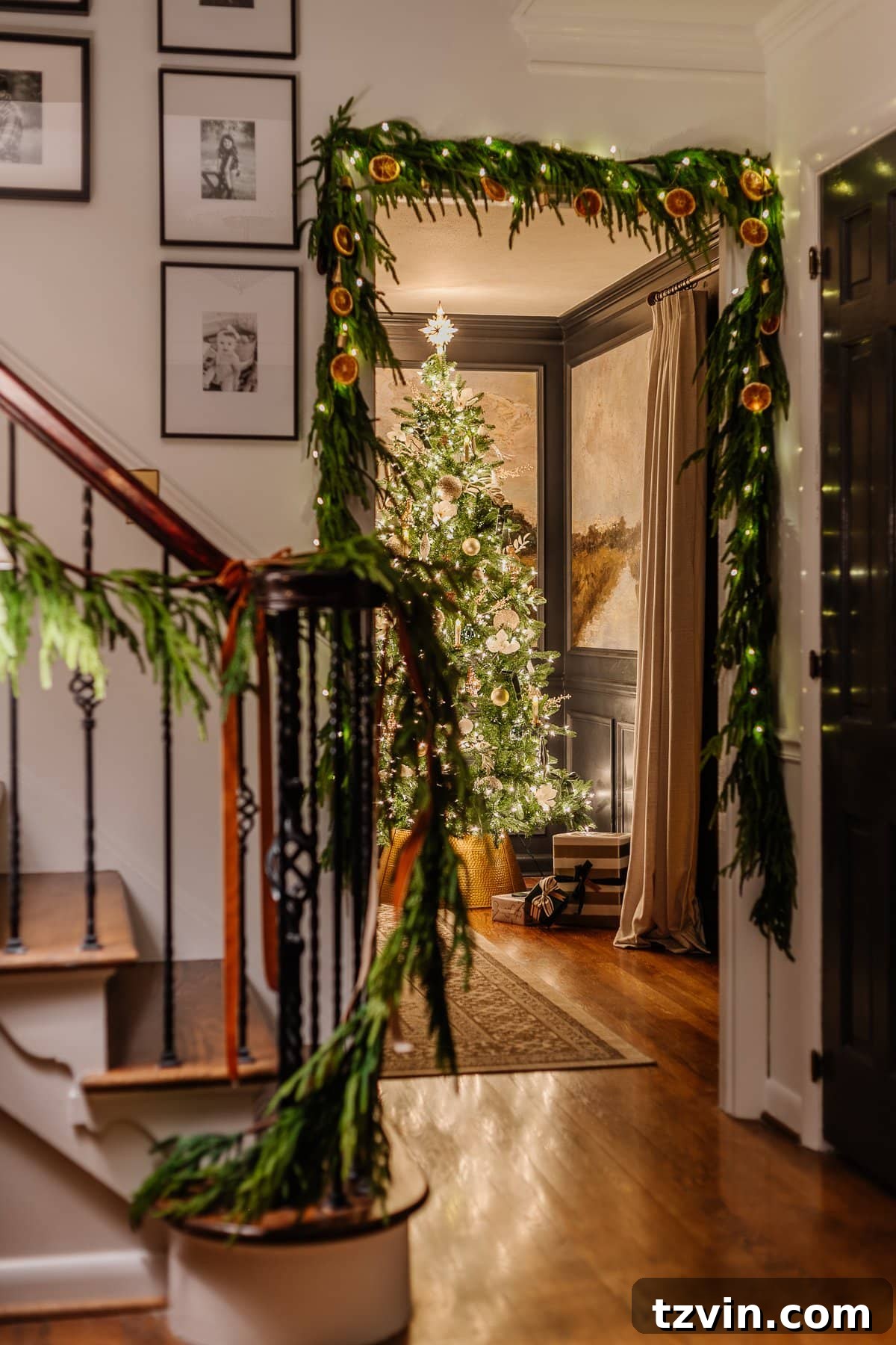 Holiday Glow Home Showcase 6 View from the foyer into the dining room, featuring a festive Christmas tree glowing with candlelight at night.