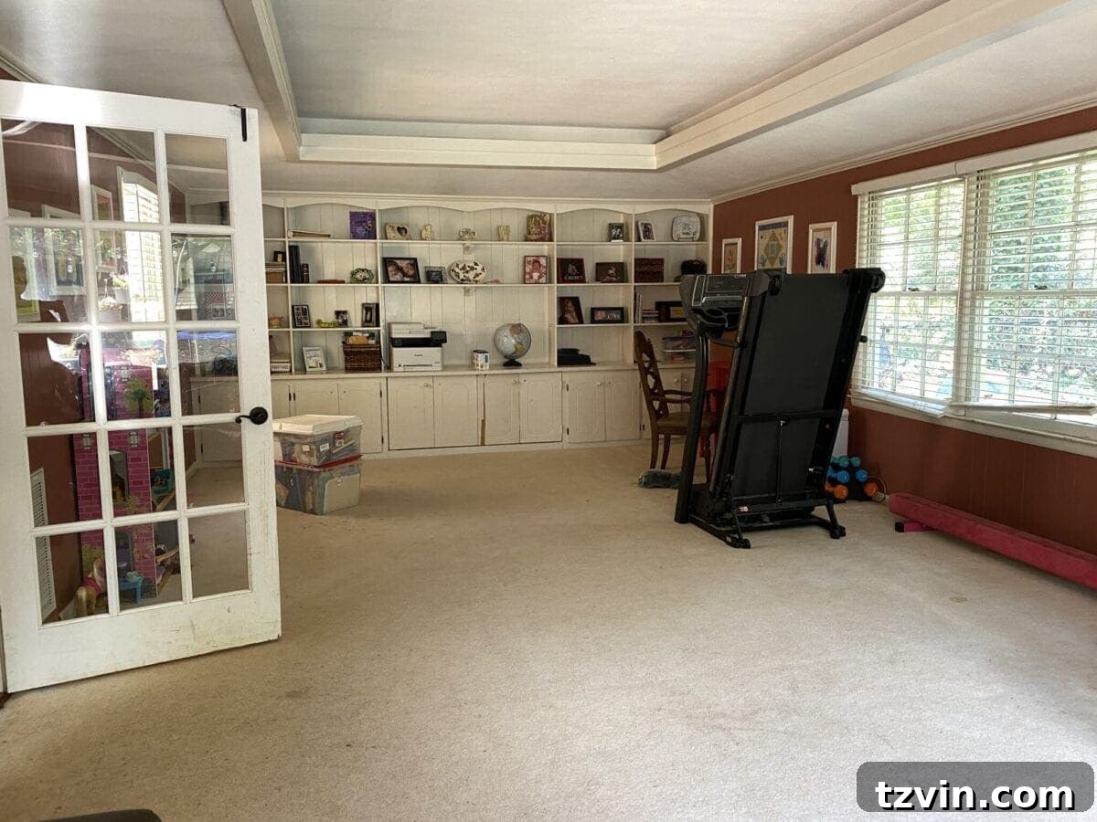 Our Favorite 21 Room Makeovers of 2021 6 Before image of the Carney family's rec room, showing a space needing organization.