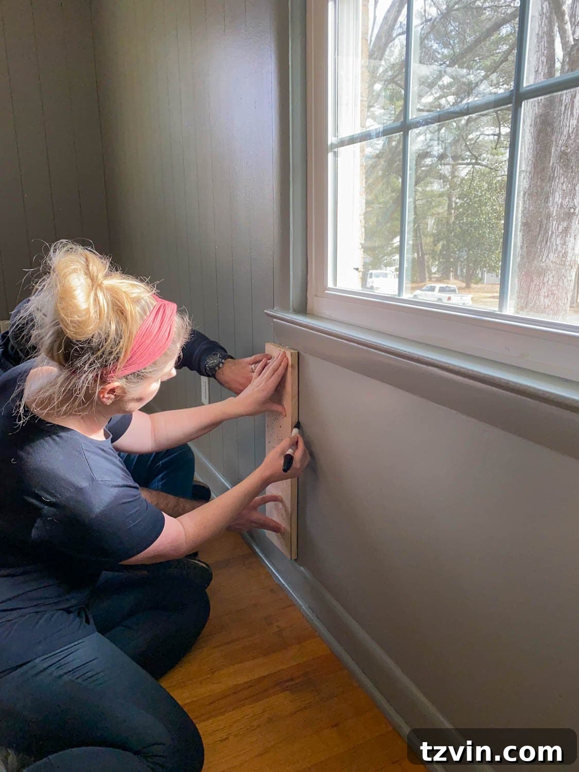 Tracing 1x6 boards with Sharpie paint pens for faux wall planking
