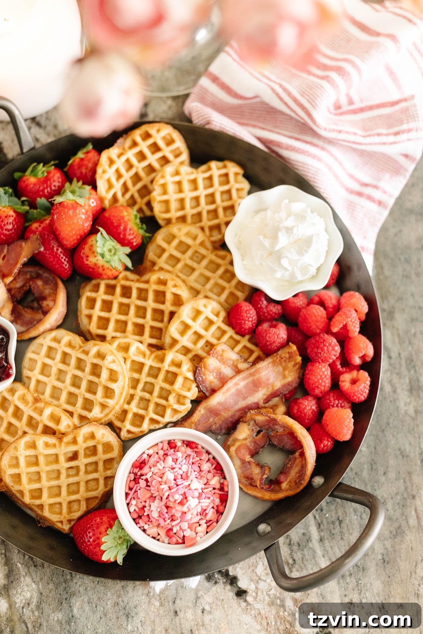 Romantic Morning Feast Board 6 Valentine's Day breakfast charcuterie board with heart shaped waffles, XO bacon, berries, and condiments on a tray