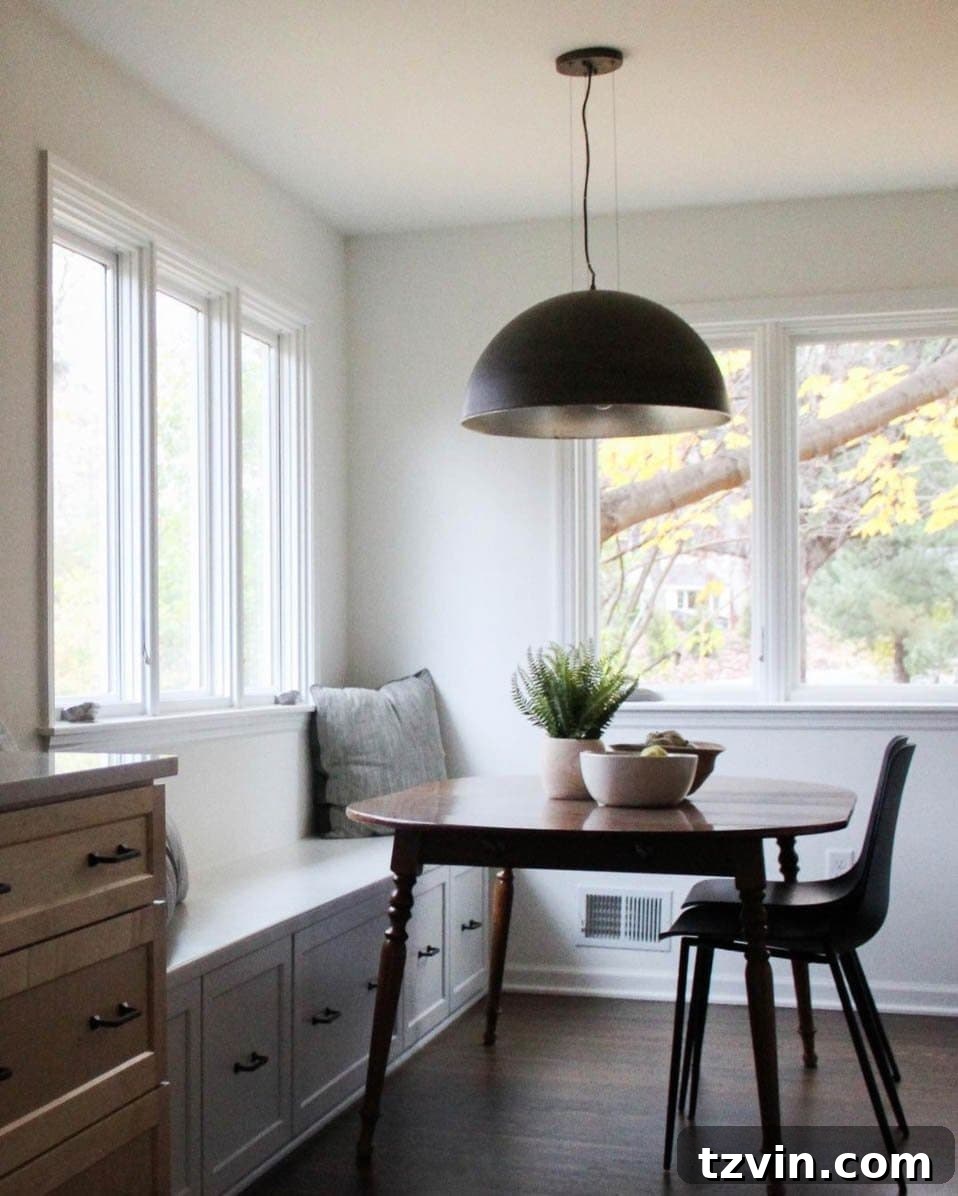 Minimalist breakfast nook idea with simple pendant light and wood table