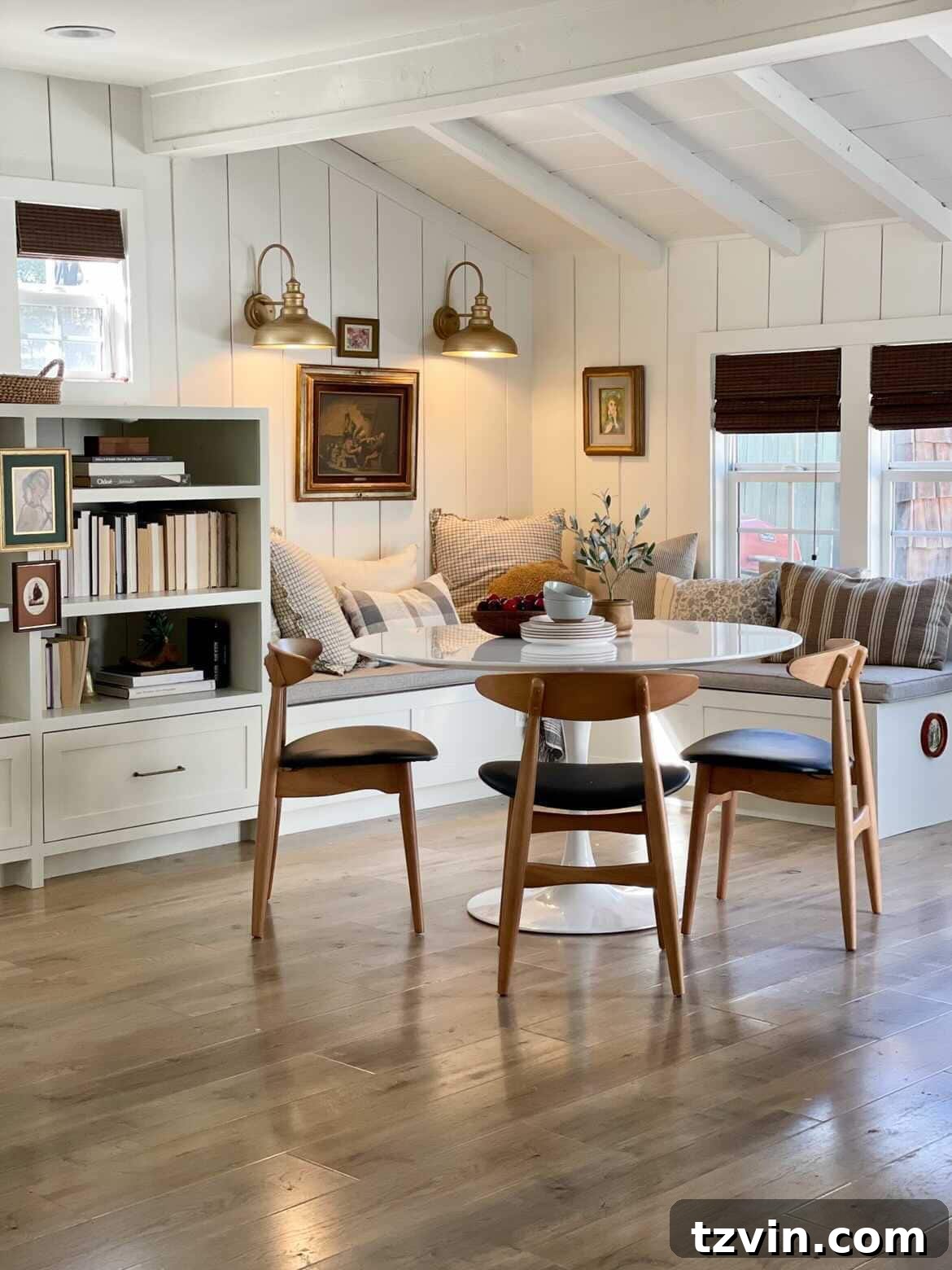 Built-in bench breakfast nook nestled next to a bookshelf for cookbook storage