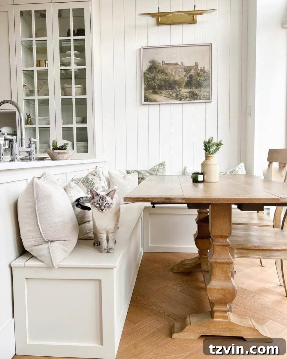 Kitchen island serving as a banquette back in a cozy breakfast nook design