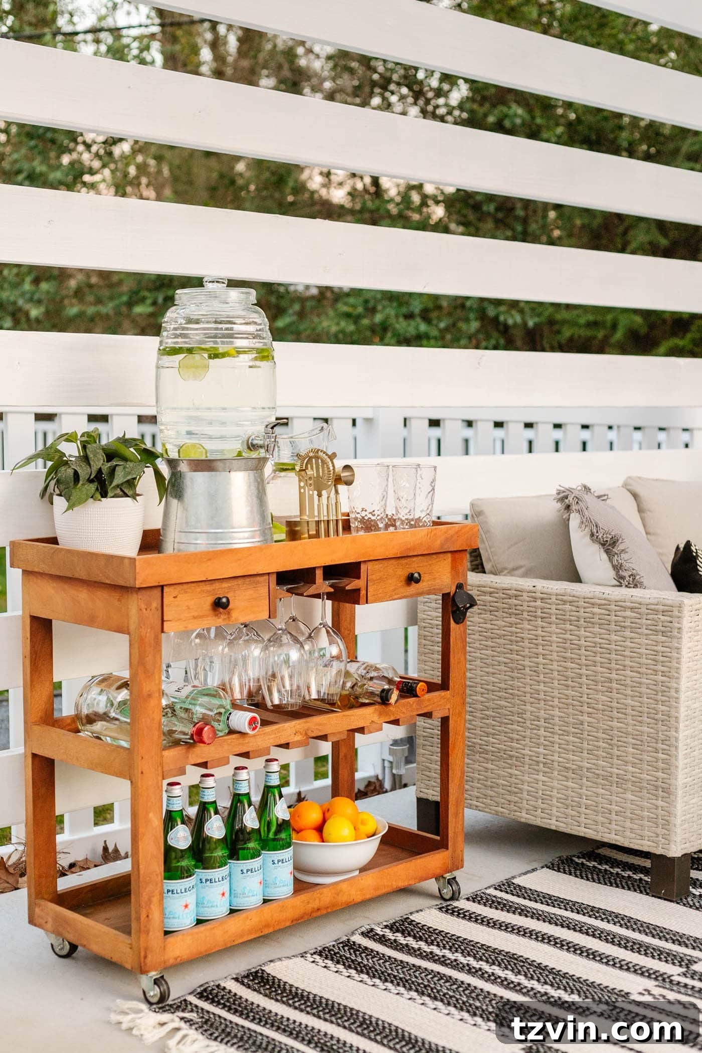 Chic outdoor bar cart styled with drinks and shatterproof glassware in a pool cabana setting, ready for entertaining