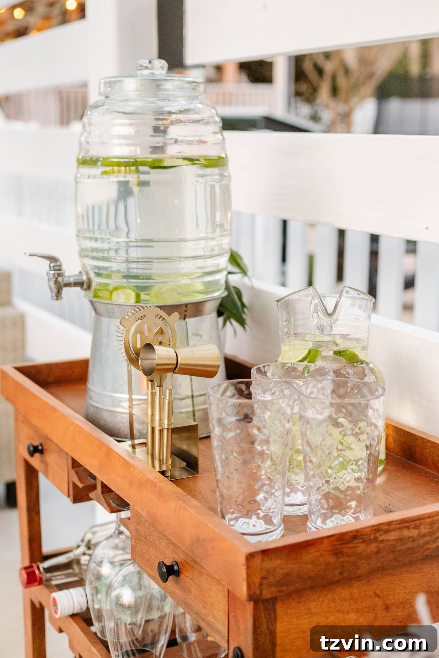 Close-up of the outdoor bar cart, showcasing practical and decorative items like glassware and a fruit bowl