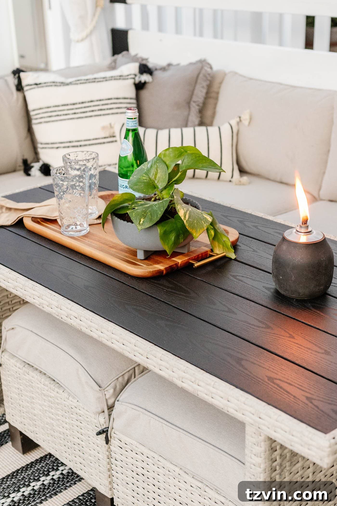 Tabletop tiki torch providing ambiance next to the Better Homes and Gardens sectional dining set with stools