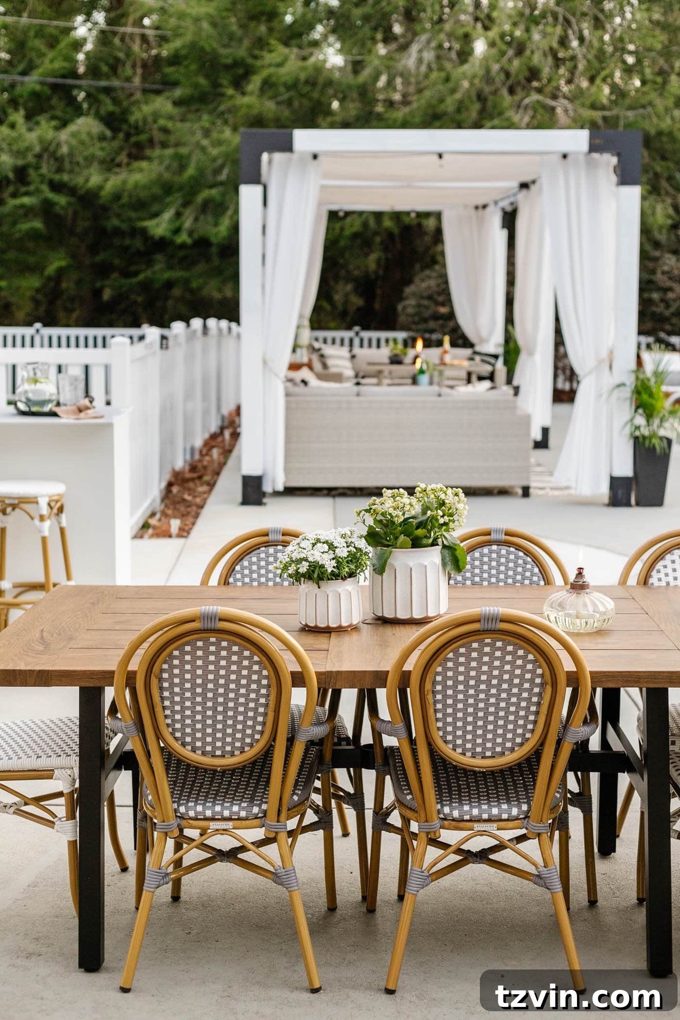 Elegant outdoor patio dining set with a metal dining table and classic French bistro chairs for al fresco meals