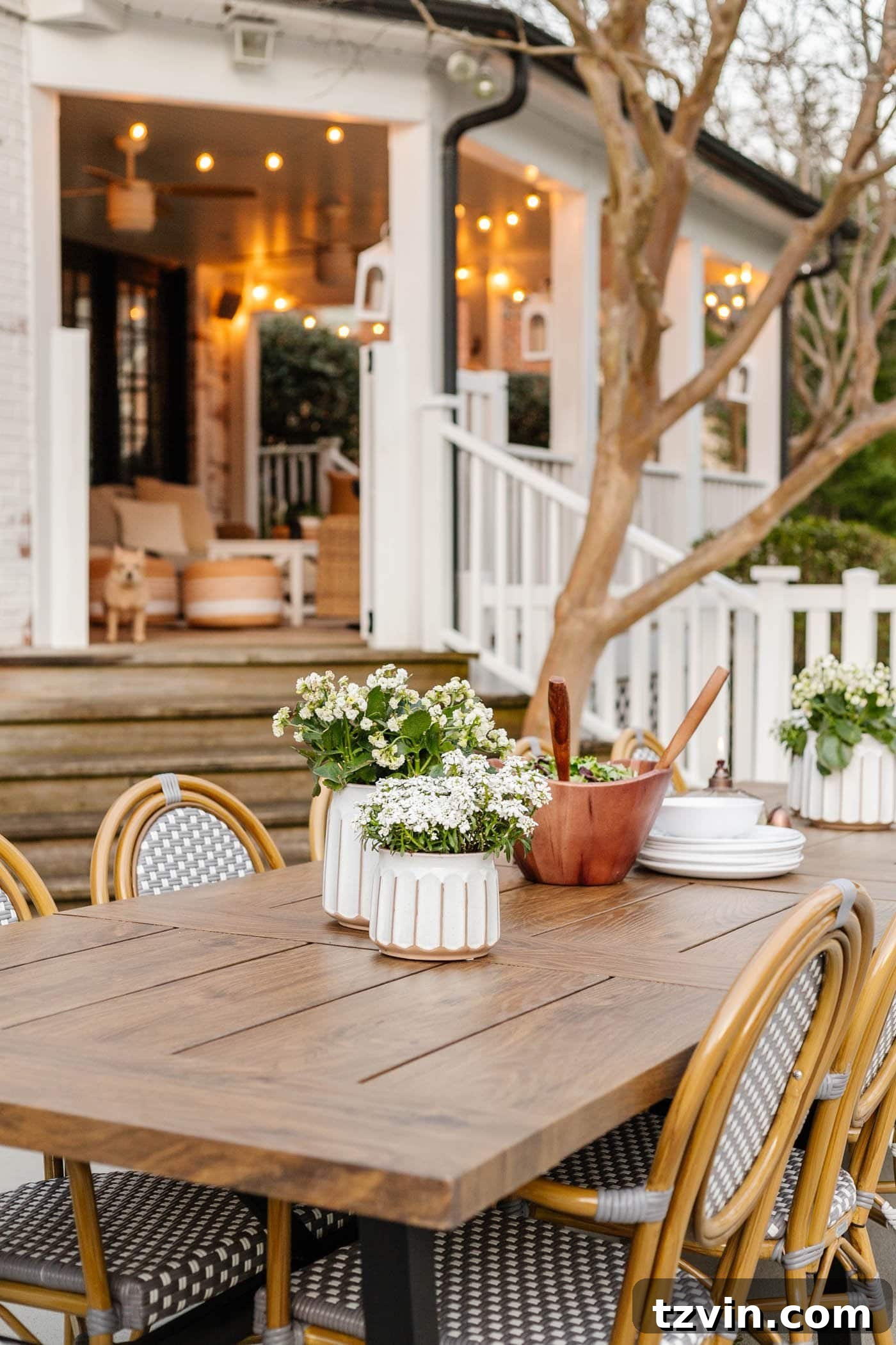 Inviting outdoor dining area featuring the durable metal table and classic French bistro chairs, perfect for family and friends