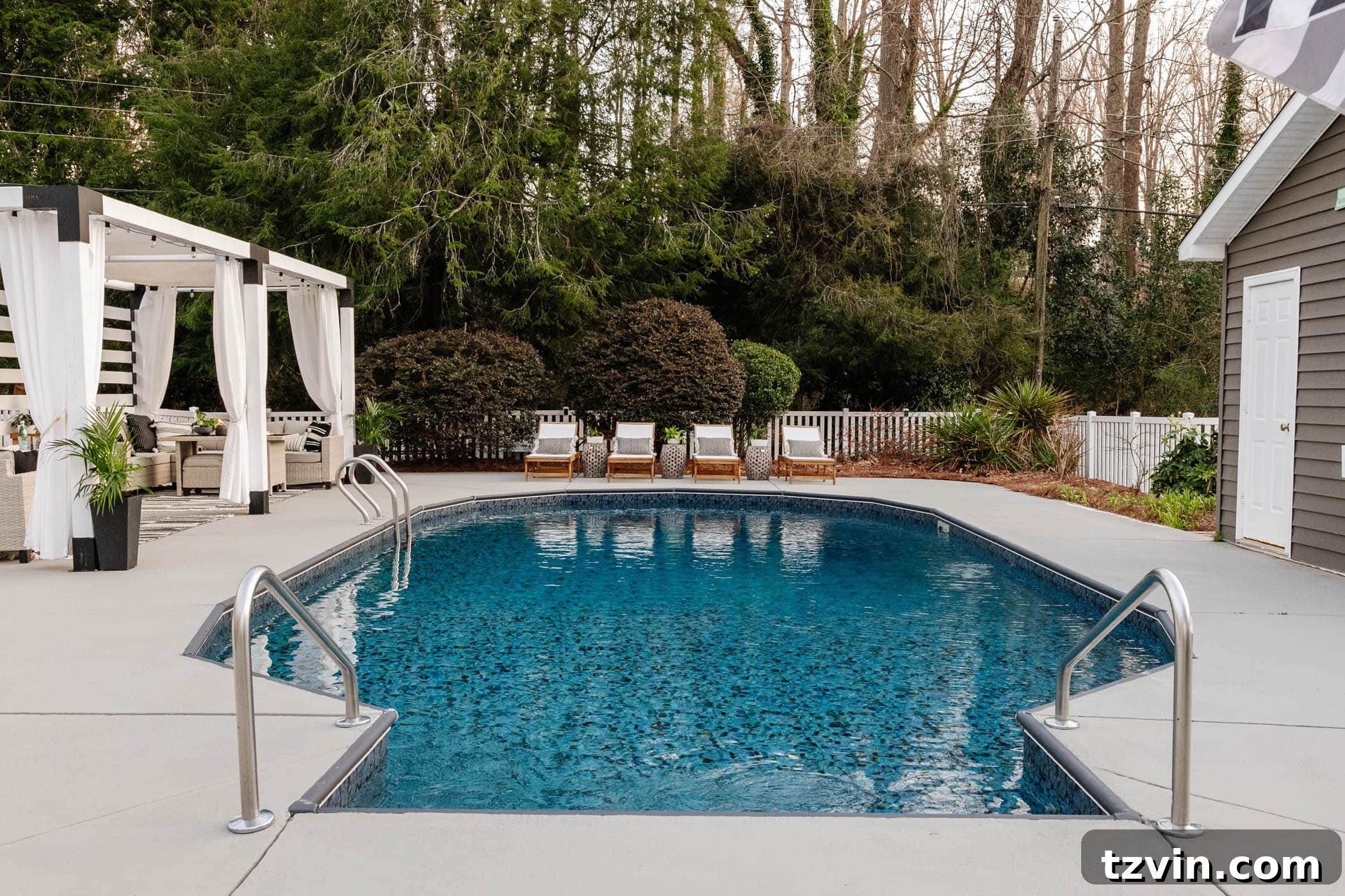 After image of the magnificent backyard swimming pool, fully renovated and inviting, surrounded by beautiful landscaping