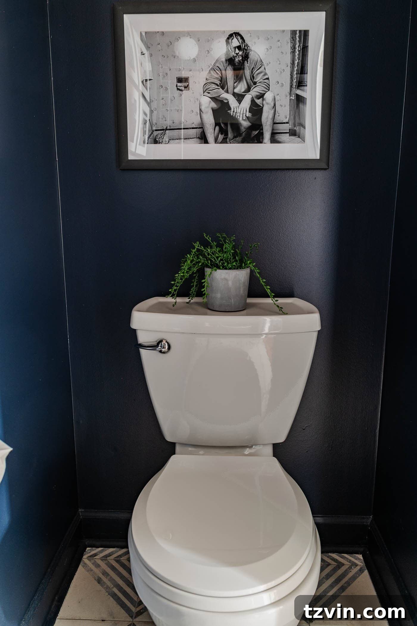 Sleek Compact Powder Room for the Modern Gentleman 11 navy blue small powder room with The Big Lebowski art above toilet