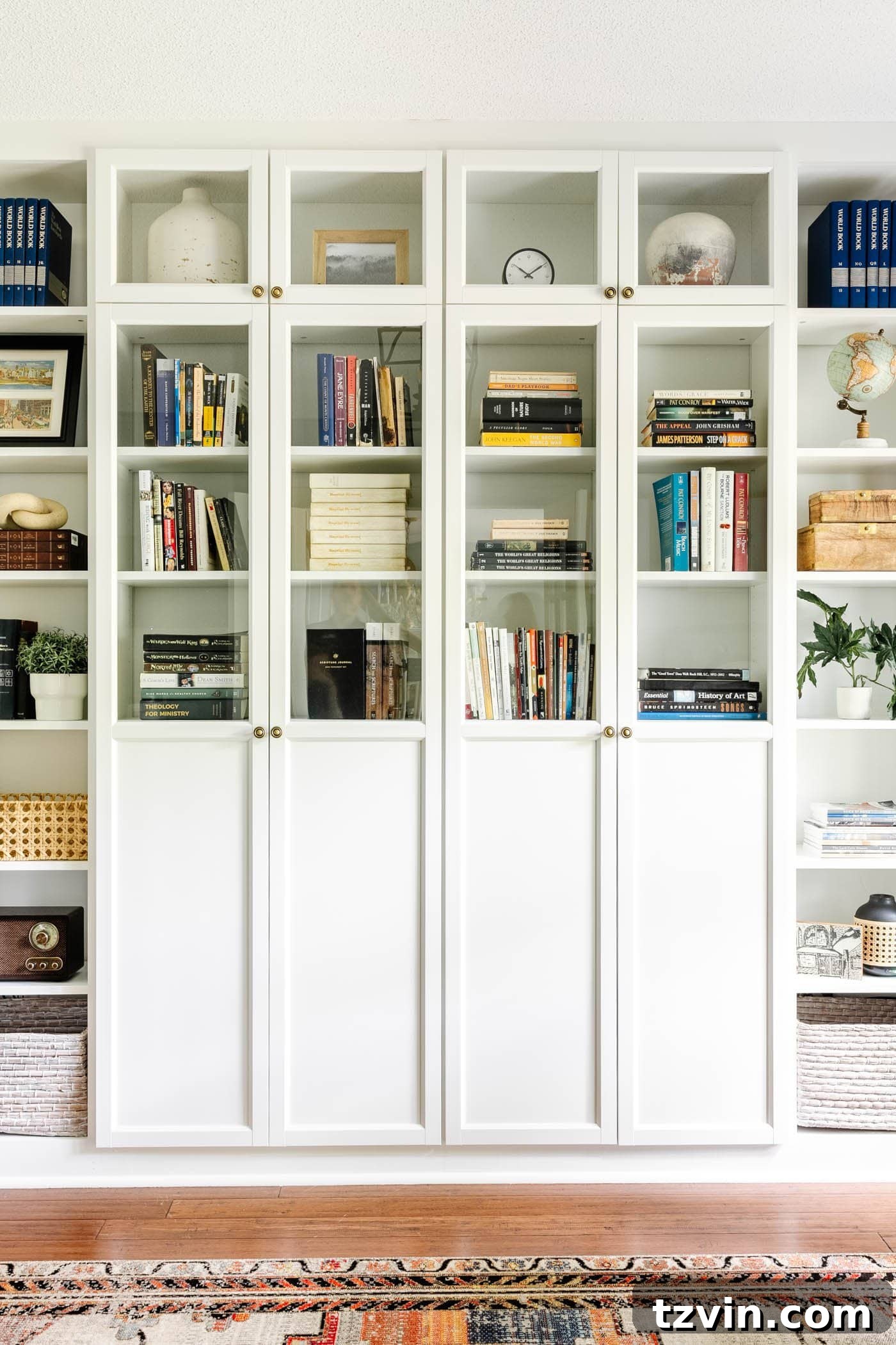 Clean white IKEA built-in shelves featuring Oxberg doors for concealed book and supply storage, contributing to a tidy and serene home office environment.