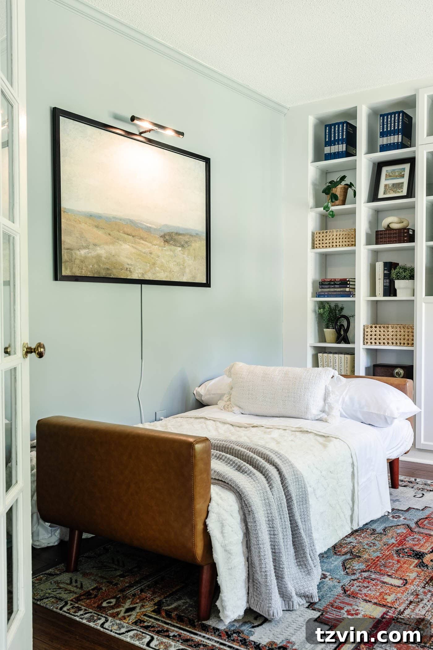 Versatile faux leather futon, expertly folded out into a comfortable bed, demonstrating its multi-purpose functionality within a modern home office setting.