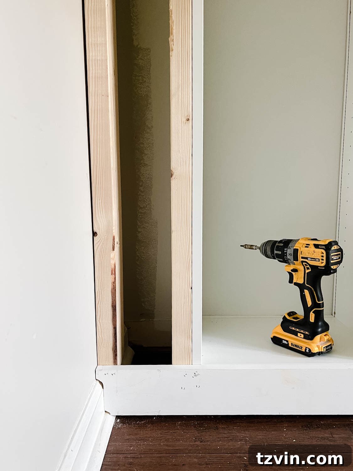 Building Custom Bookshelves with IKEA Billy Bookcase Hacks 19 1x4 board cut to the shape of a baseboard to make it look flush against the wall