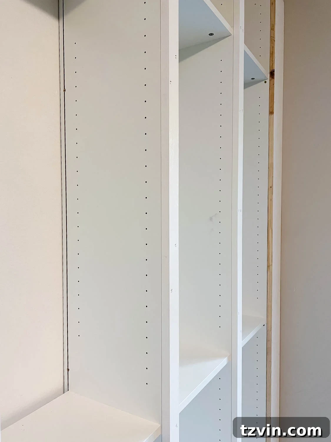 trimmed 1x10 board to fit the front of bookcases and fill the gap to make them look built in for the IKEA Billy bookcase hack