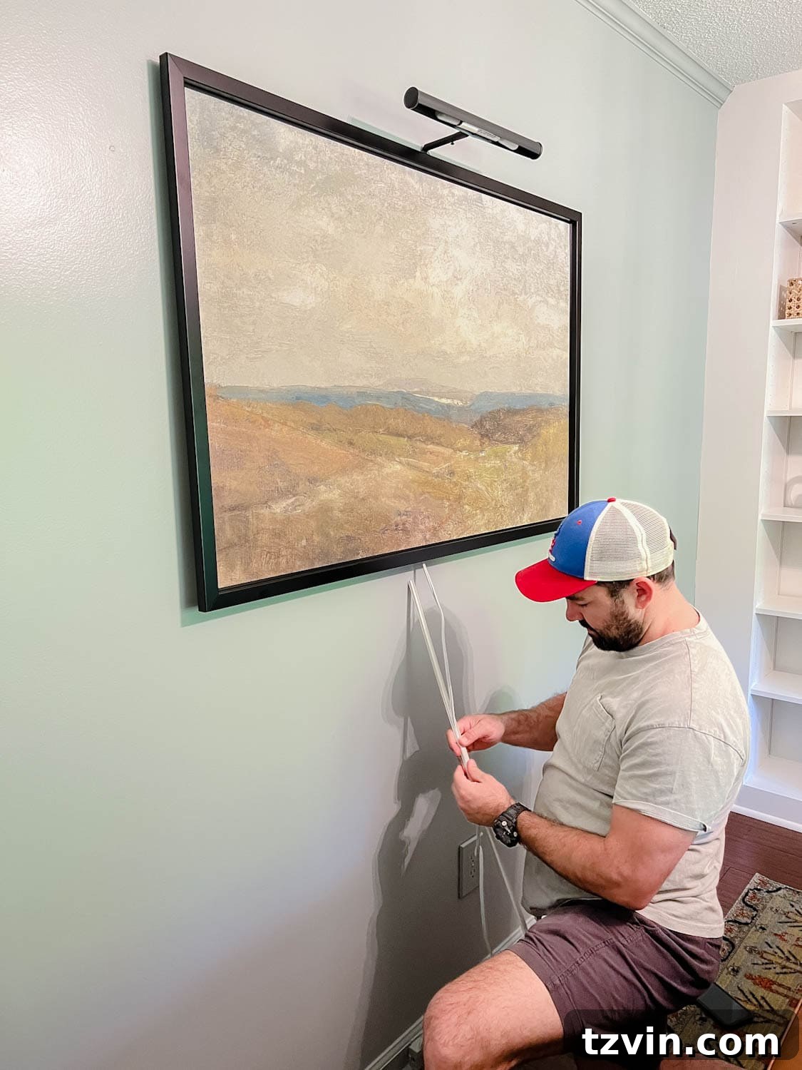 Installing a picture light above art, concealing the cord with covers