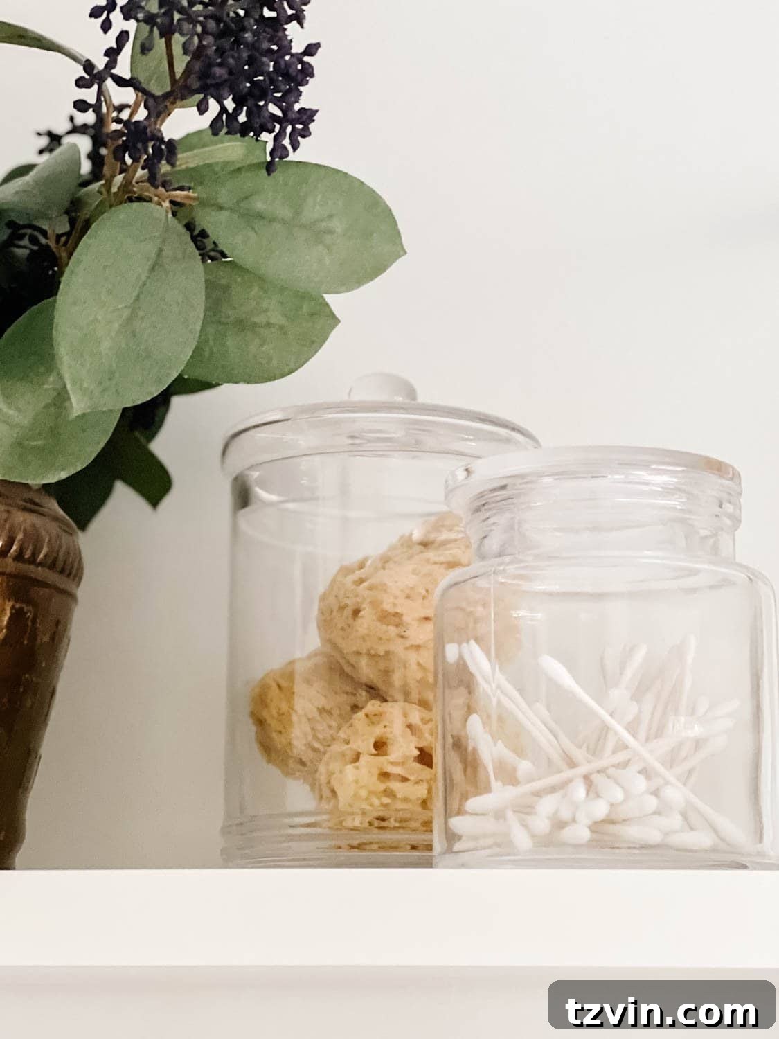 Attainable Luxury: Spa Bathroom Ideas for Every Home 10 apothecary jars with q tips and bath sponges for spa bathroom storage