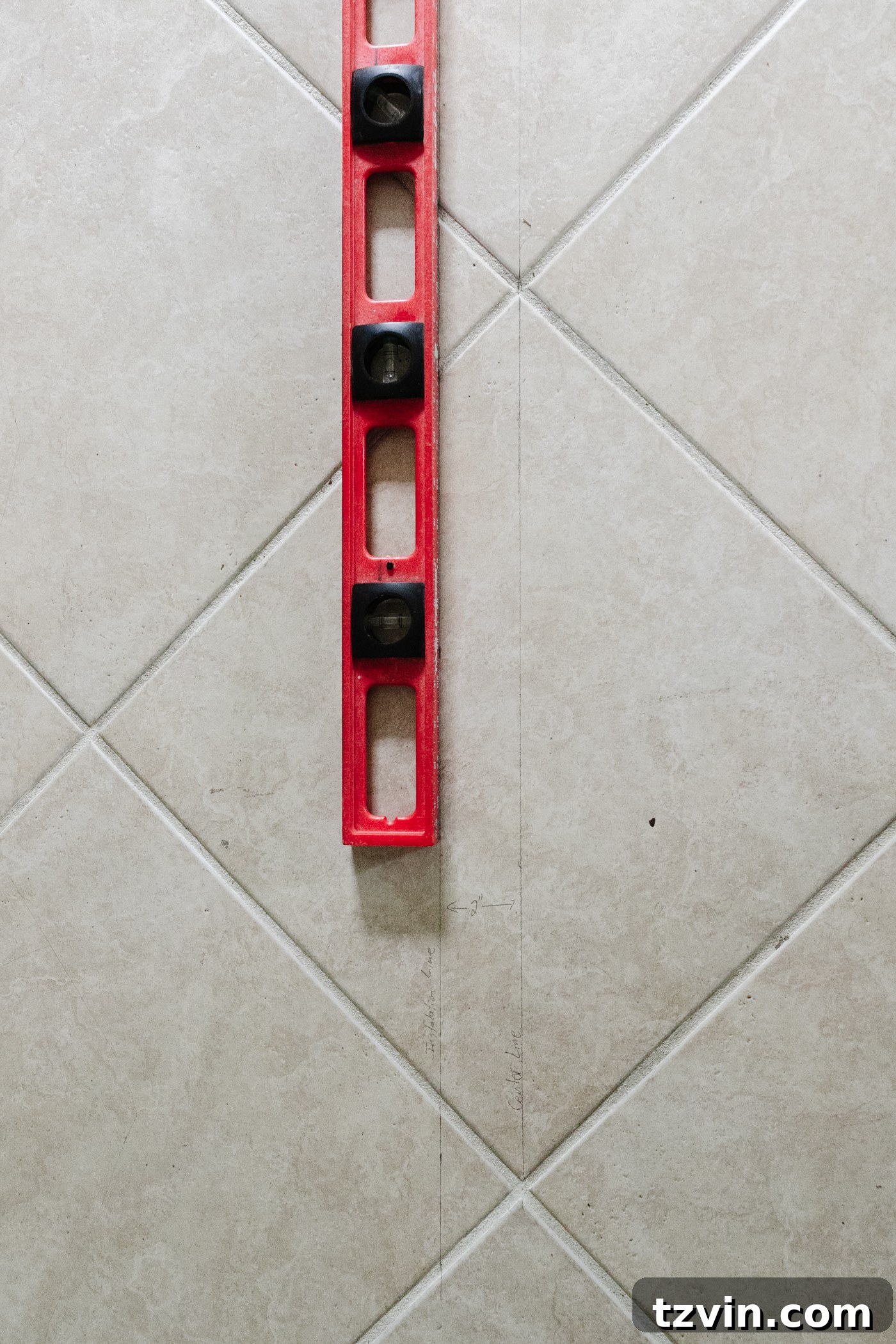 using a level to draw a starting line to lay flooring