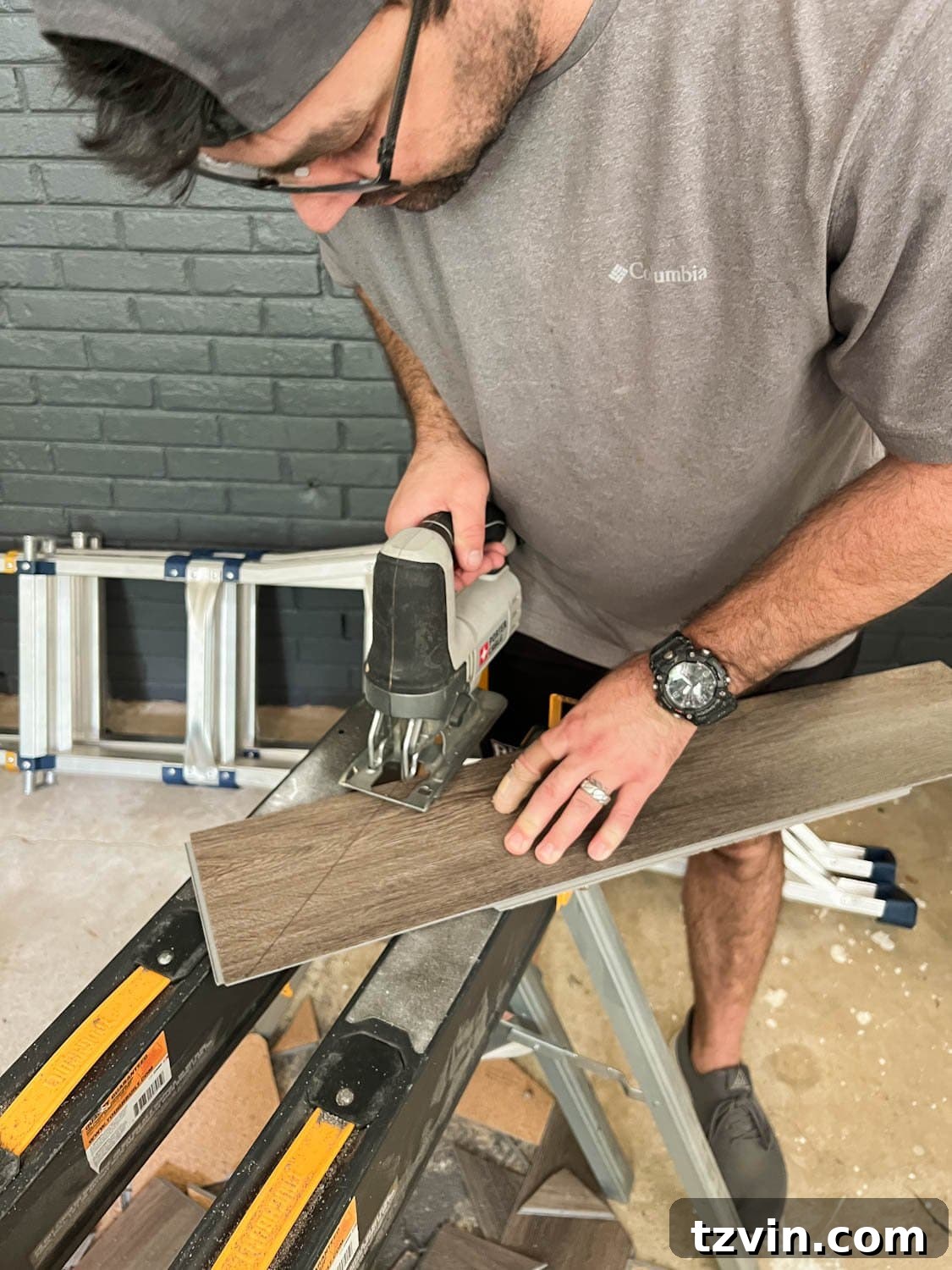 cutting a piece of LVP floor with a jigsaw