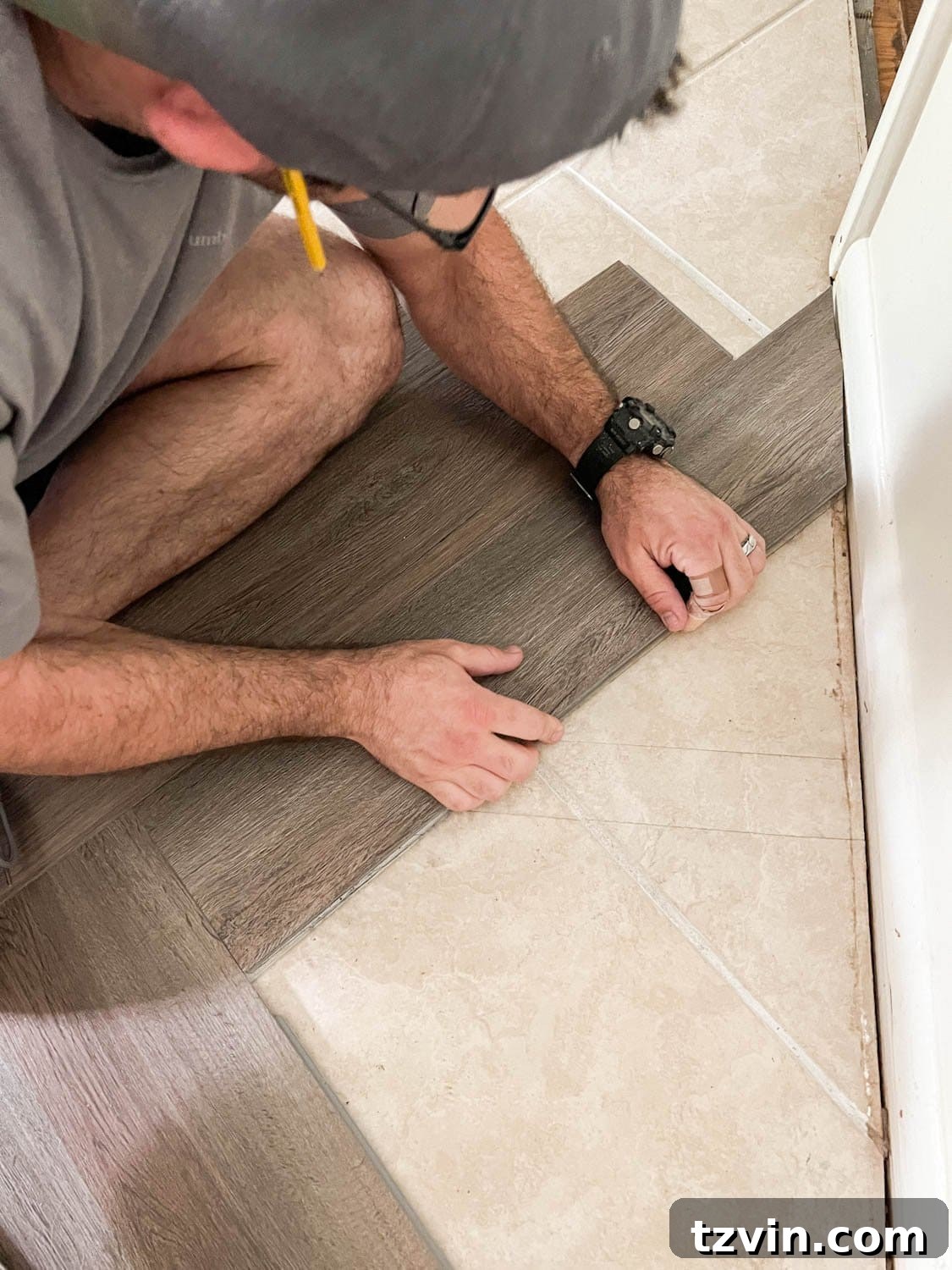 fitting herringbone vinyl flooring against a wall's edge