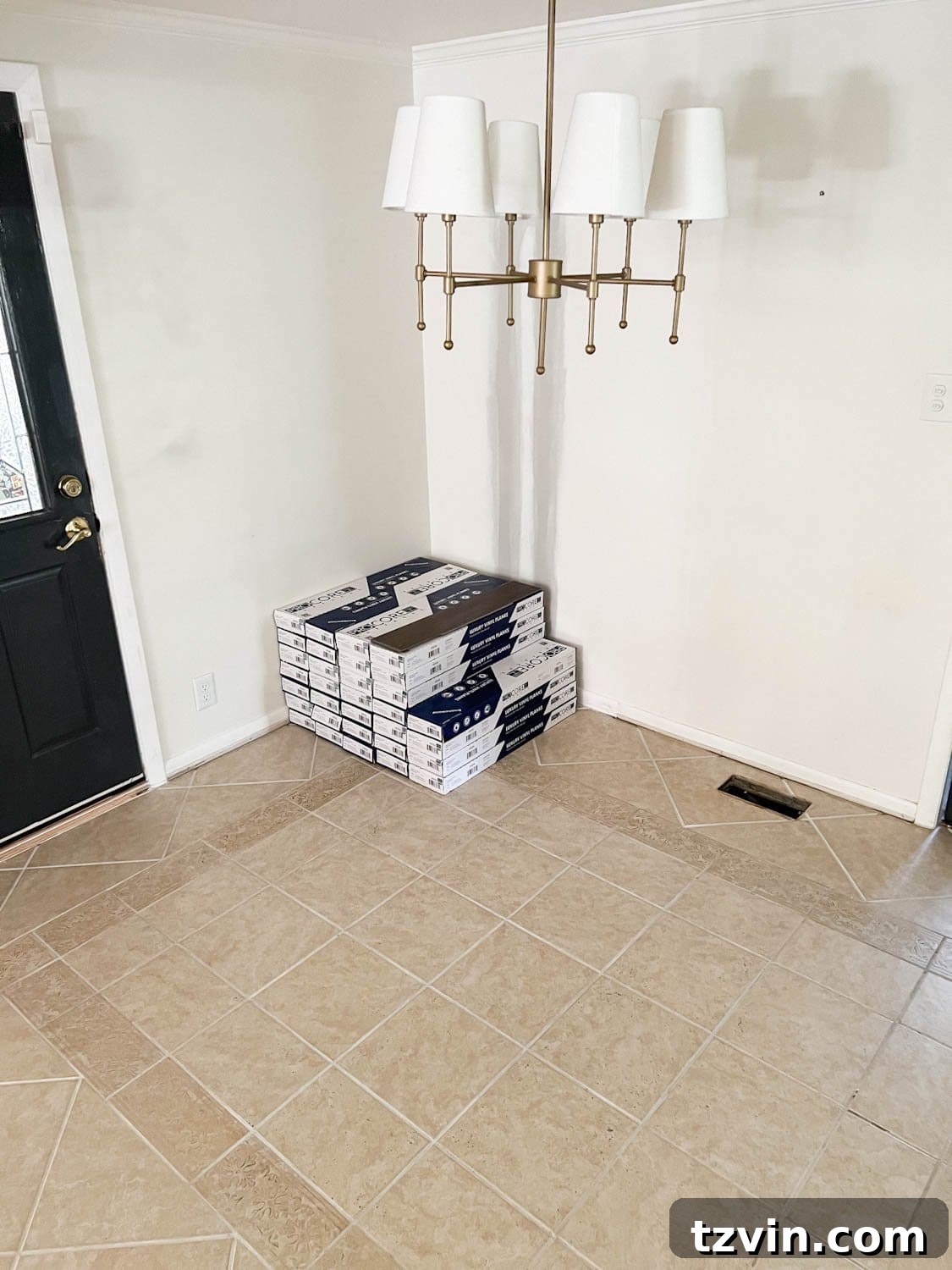 stack of LVP flooring on top of tile floor