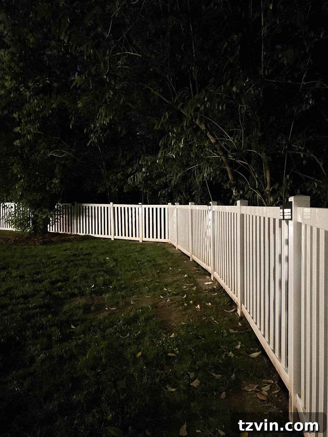 Illuminate Your Nights: Simple DIY Backyard Lighting Projects 11 multiple solar step lights attached to fence posts, softly illuminating a backyard at night