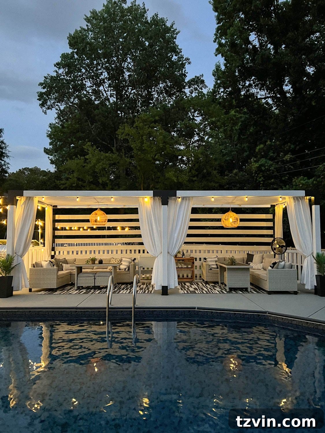 Illuminate Your Nights: Simple DIY Backyard Lighting Projects 15 a poolside cabana pergola in a backyard, beautifully lit with string lights and solar pendant lights, featuring elegant white outdoor curtains