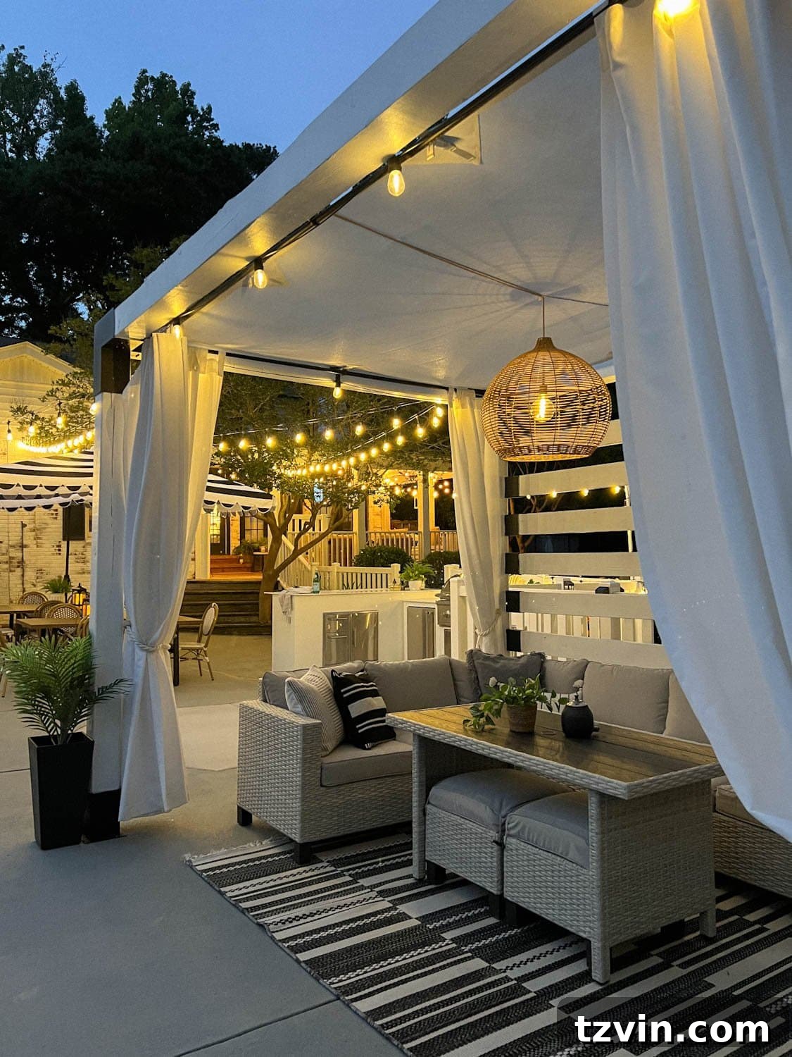 Illuminate Your Nights: Simple DIY Backyard Lighting Projects 5 a backyard pool cabana adorned with string lights and a solar pendant light hanging above comfortable patio furniture