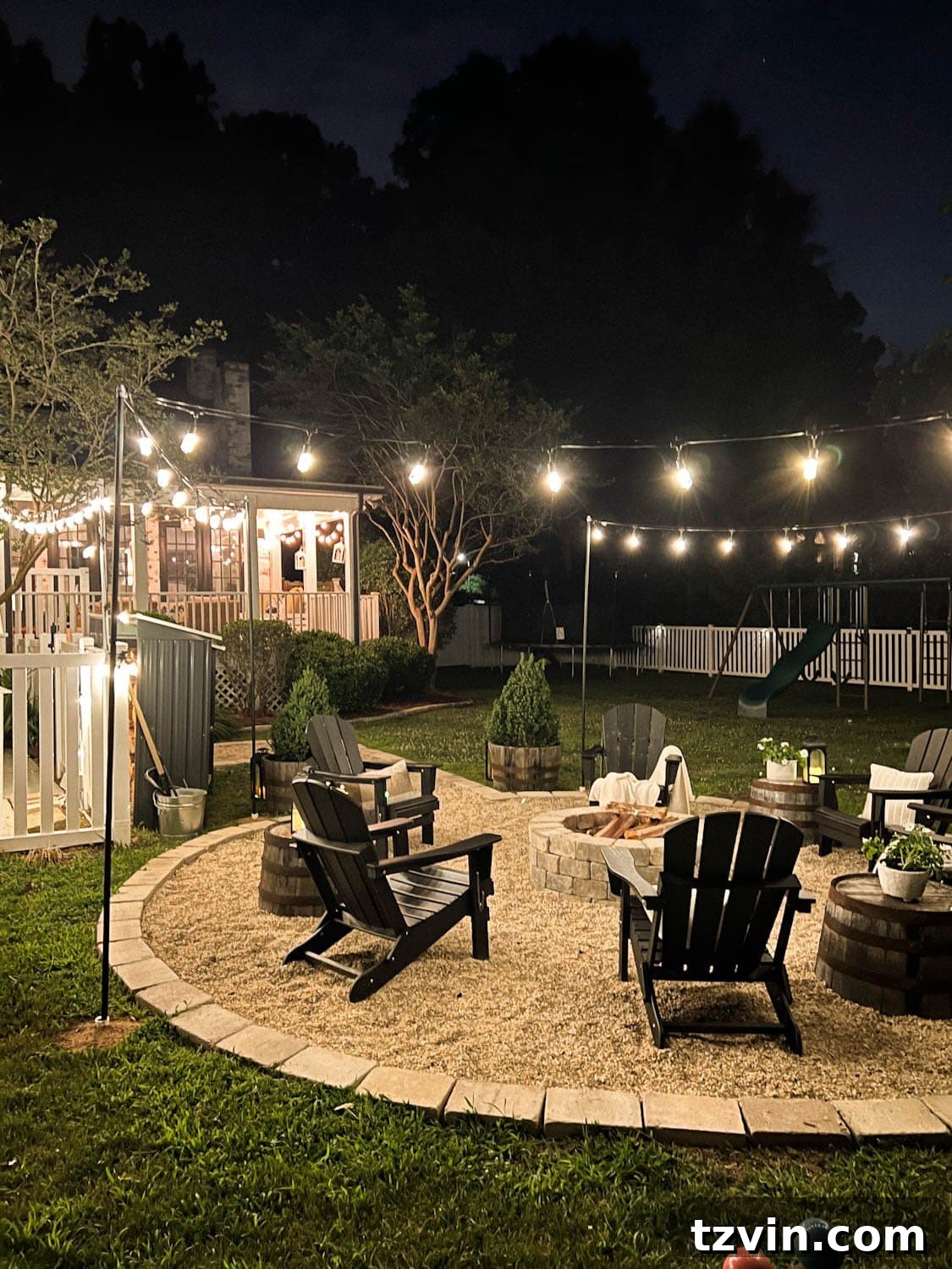 Creative String Light Solutions for Every Backyard Corner 30 fire pit at night time with string lights in a backyard