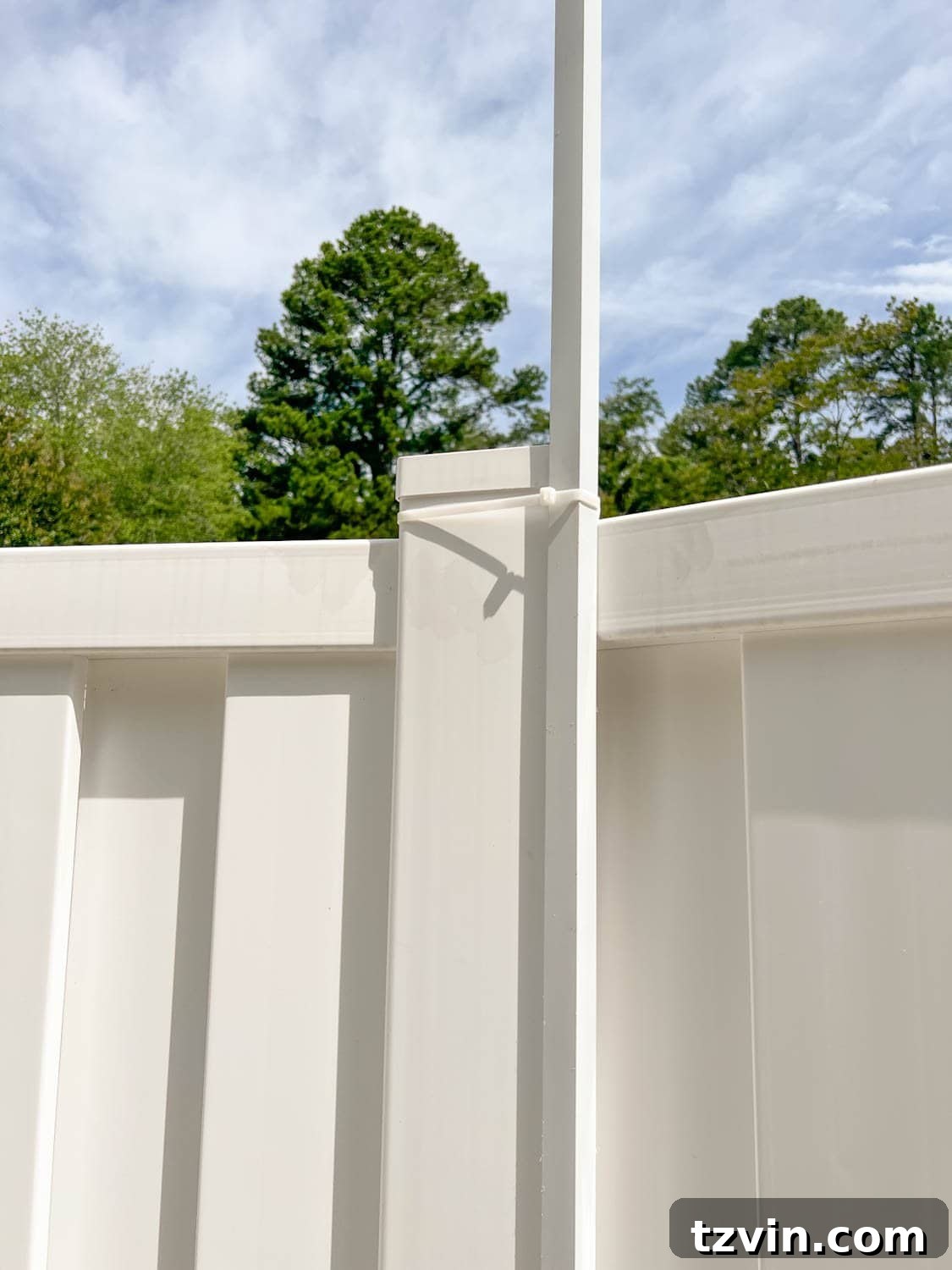 Creative String Light Solutions for Every Backyard Corner 36 white square tubing attached with zip ties on a fence