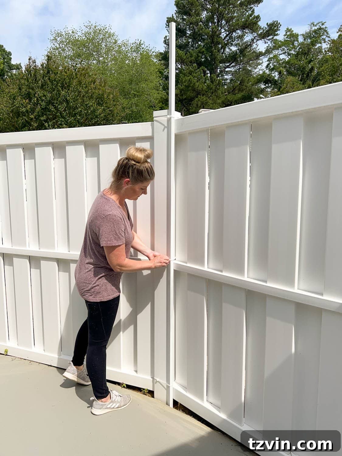 Creative String Light Solutions for Every Backyard Corner 37 placing white square tubing attached with zip ties to hang string lights on a fence
