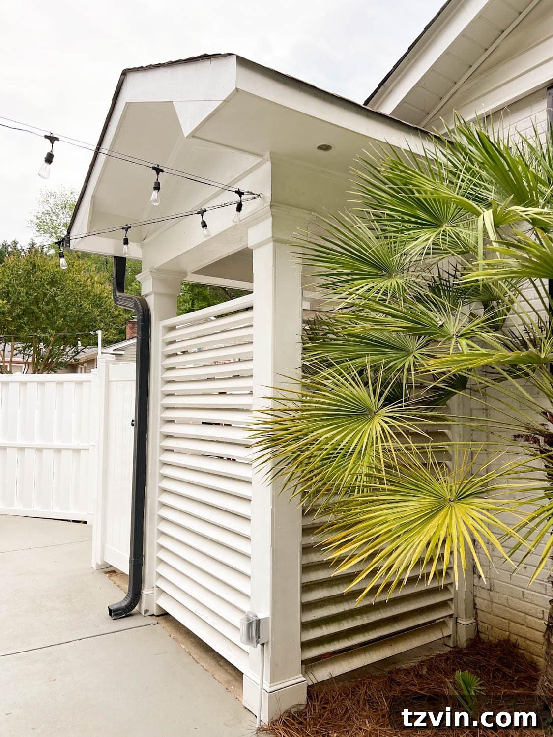 Creative String Light Solutions for Every Backyard Corner 42 hanging string lights from a building using a cable system