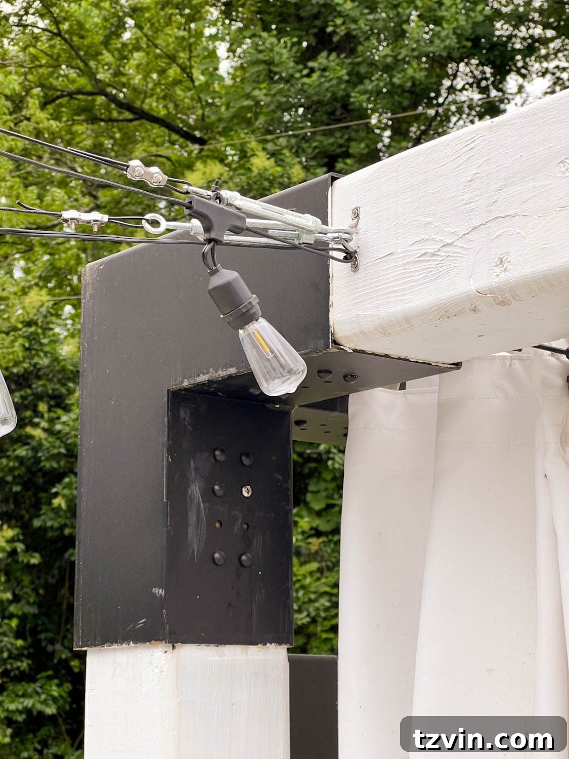 Creative String Light Solutions for Every Backyard Corner 43 hanging lights from a pergola using cables