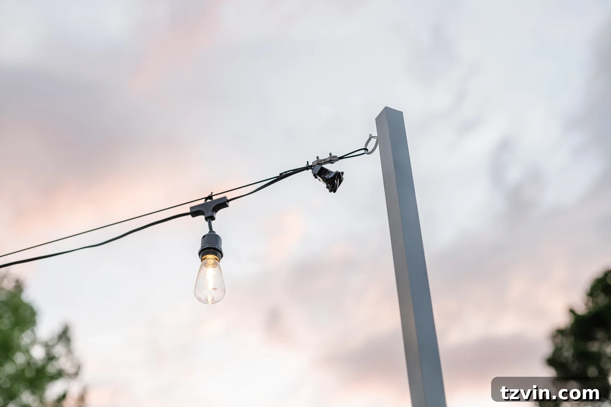 Creative String Light Solutions for Every Backyard Corner 46 end of string light strand hanging from DIY string light pole