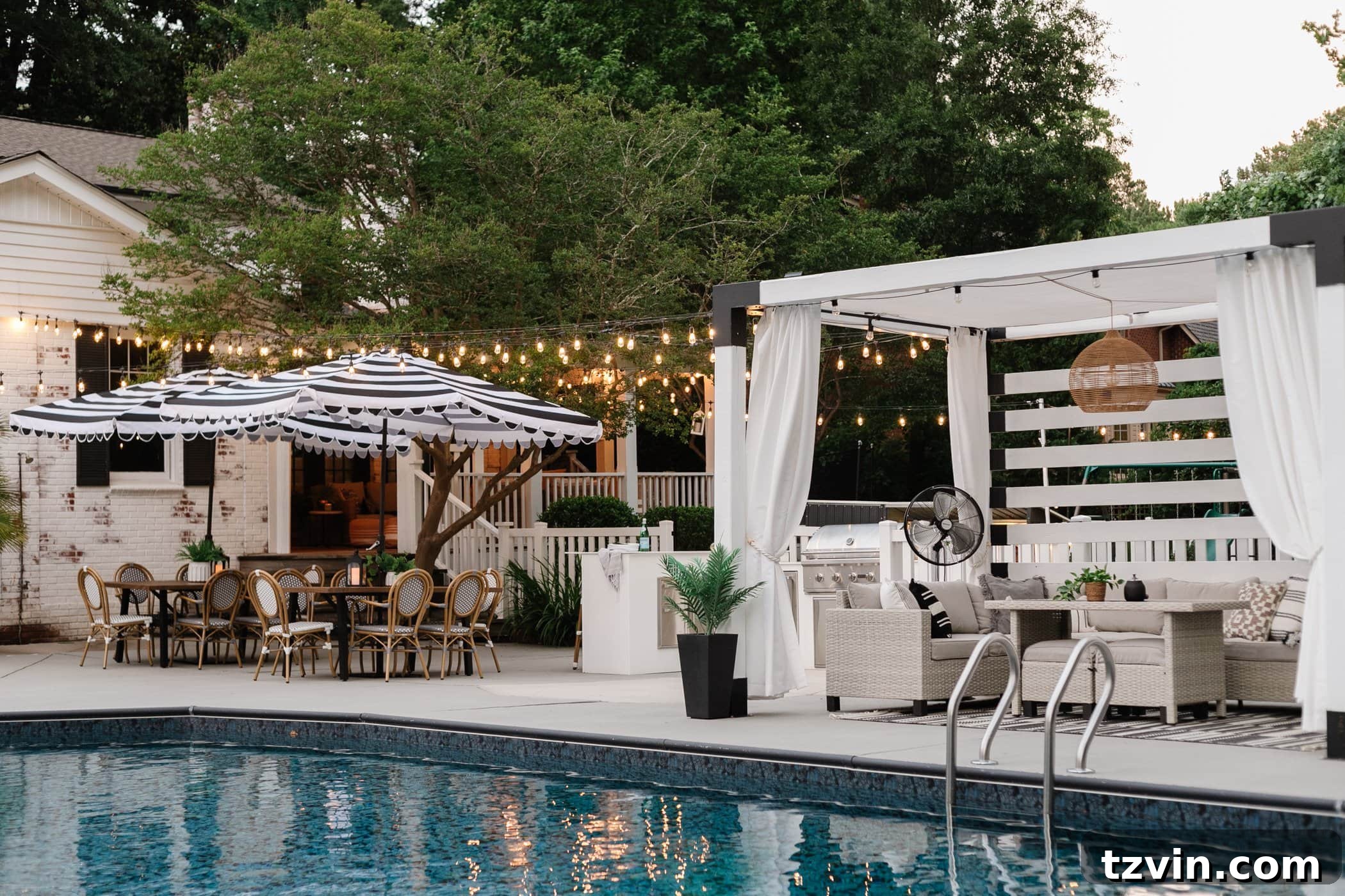 Creative String Light Solutions for Every Backyard Corner 48 string lights hanging around a pool with pergola and outdoor dining tables
