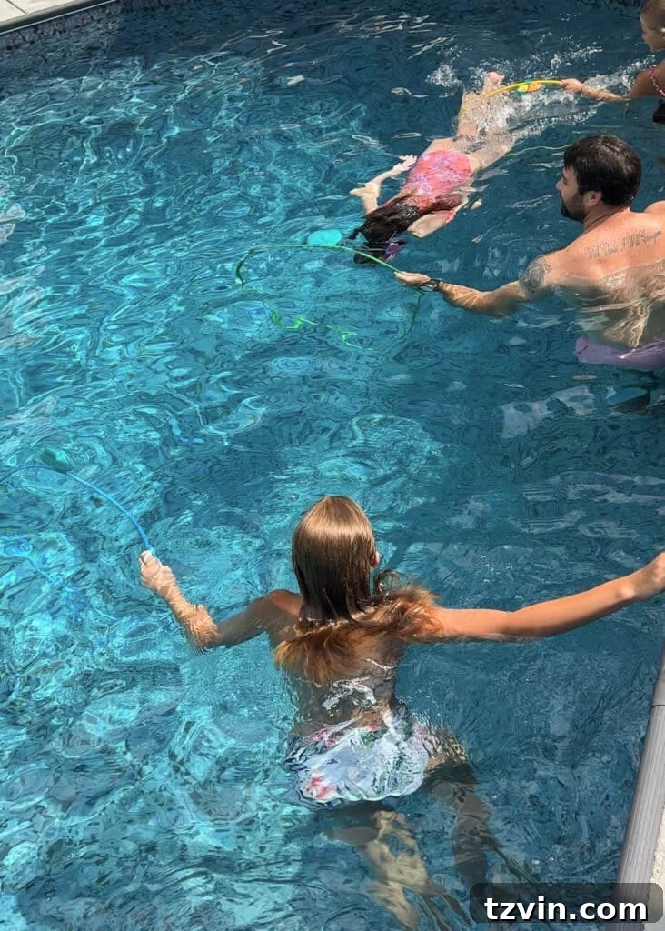 family playing with pool toys using swim through rings 