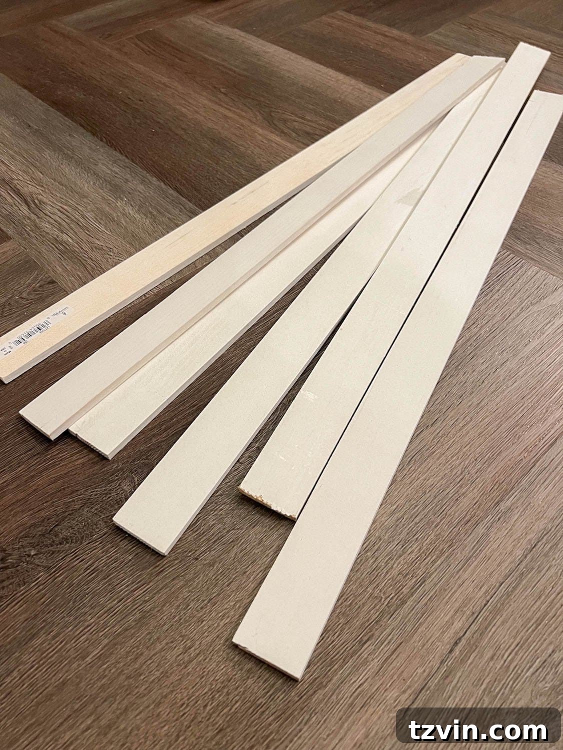 Create a Budget Batten Wall with Lattice Strips 4 A stack of pre-primed wooden lattice strips, ready for a DIY batten wall project