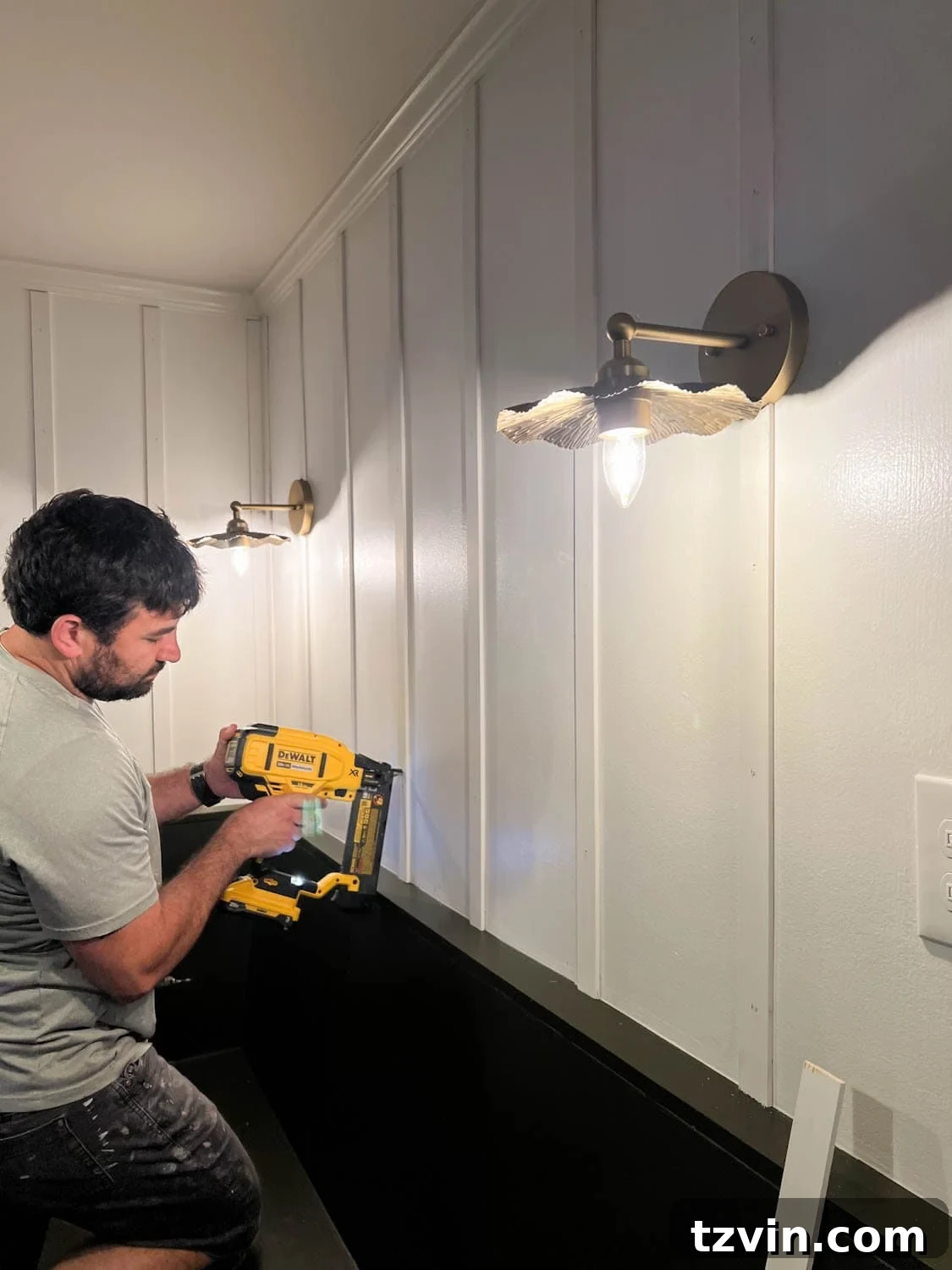 Create a Budget Batten Wall with Lattice Strips 8 A close-up of lattice strips being nailed to a wall to create DIY batten wall molding