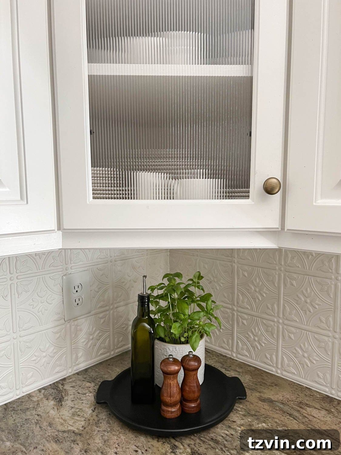 Elevate Your Home Decor with Affordable Window Film 4 reeded glass cabinet and kitchen countertop decorative tray with potted herbs, bottle of olive oil, and salt and pepper grinders