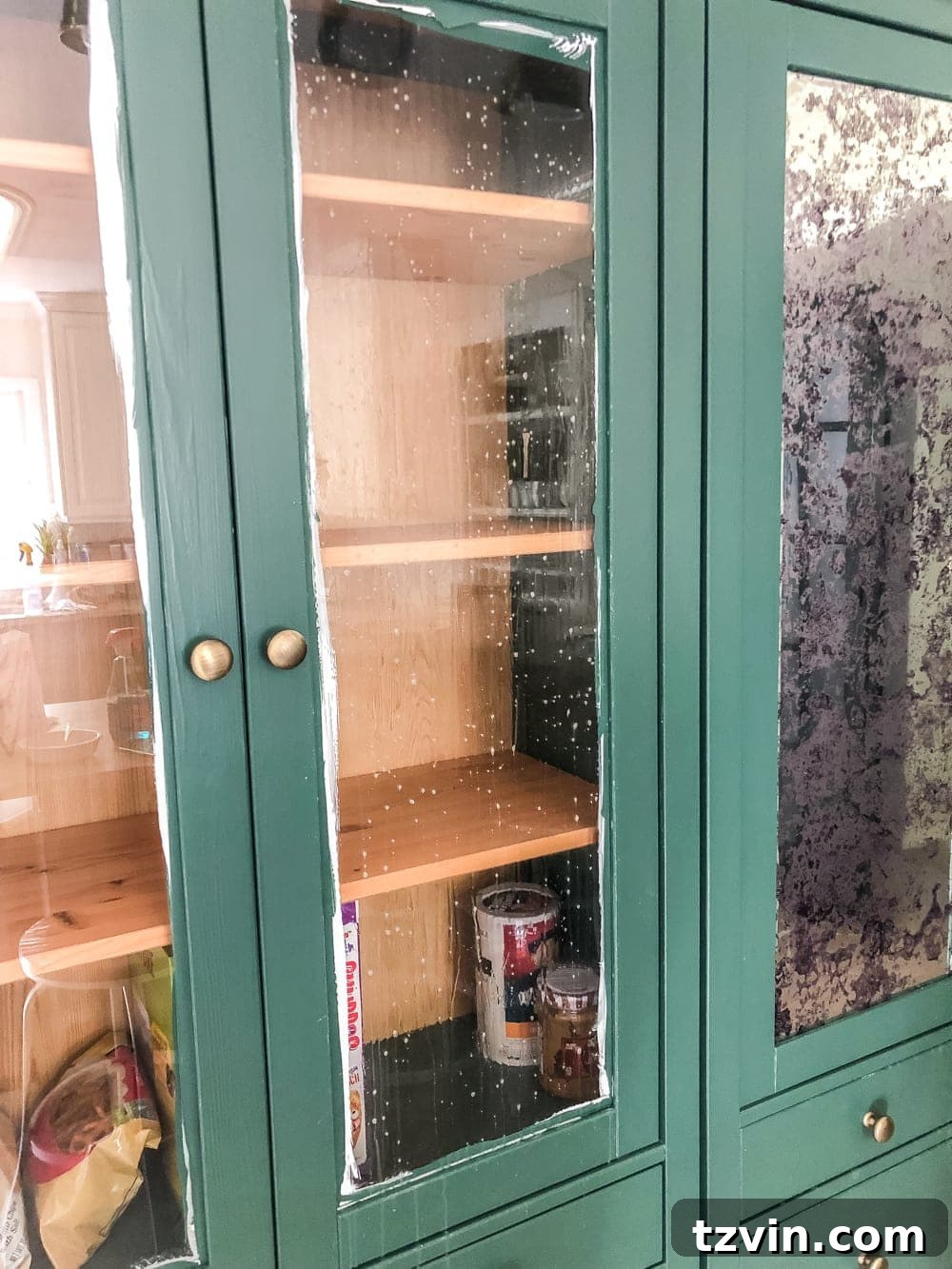 Elevate Your Home Decor with Affordable Window Film 7 glass front cabinet sprayed with water
