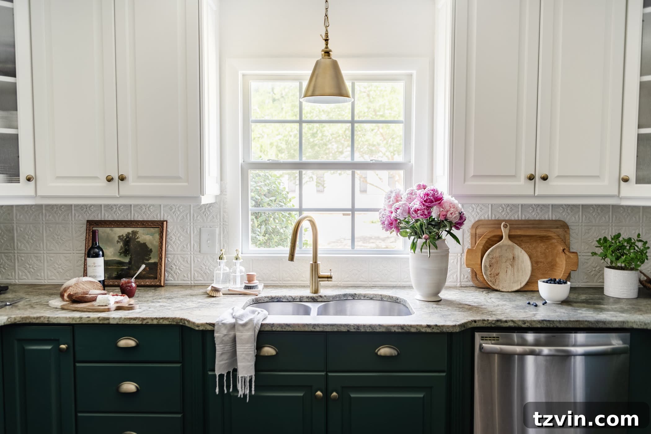 kitchen countertop decor and sink in front of window with vase of peonies, cutting boards, and printable kitchen artwork  