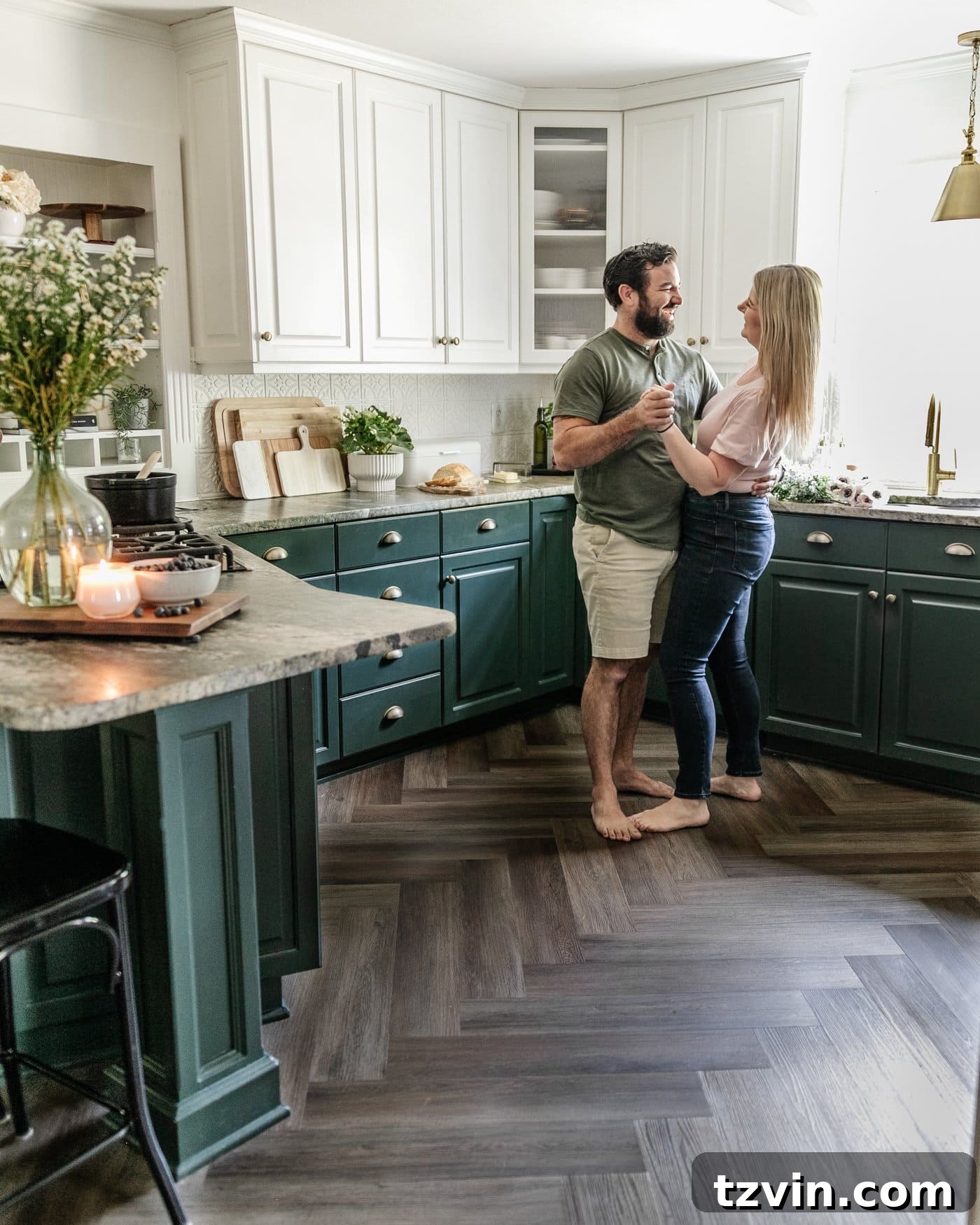 Kitchen and Nook Amazing Makeover 19 A joyful moment of dancing on the new herringbone LVP floors in a beautifully refreshed kitchen, celebrating the transformation.