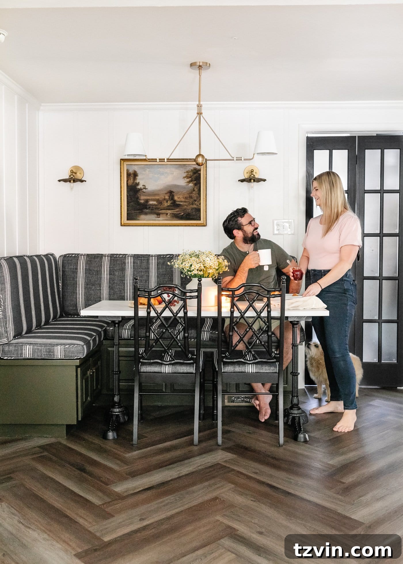 Kitchen and Nook Amazing Makeover 4 Styled breakfast nook featuring a striped banquette bench, elegant marble table, and beautiful herringbone LVP floors from ProCore Floors, showcasing a cohesive design.