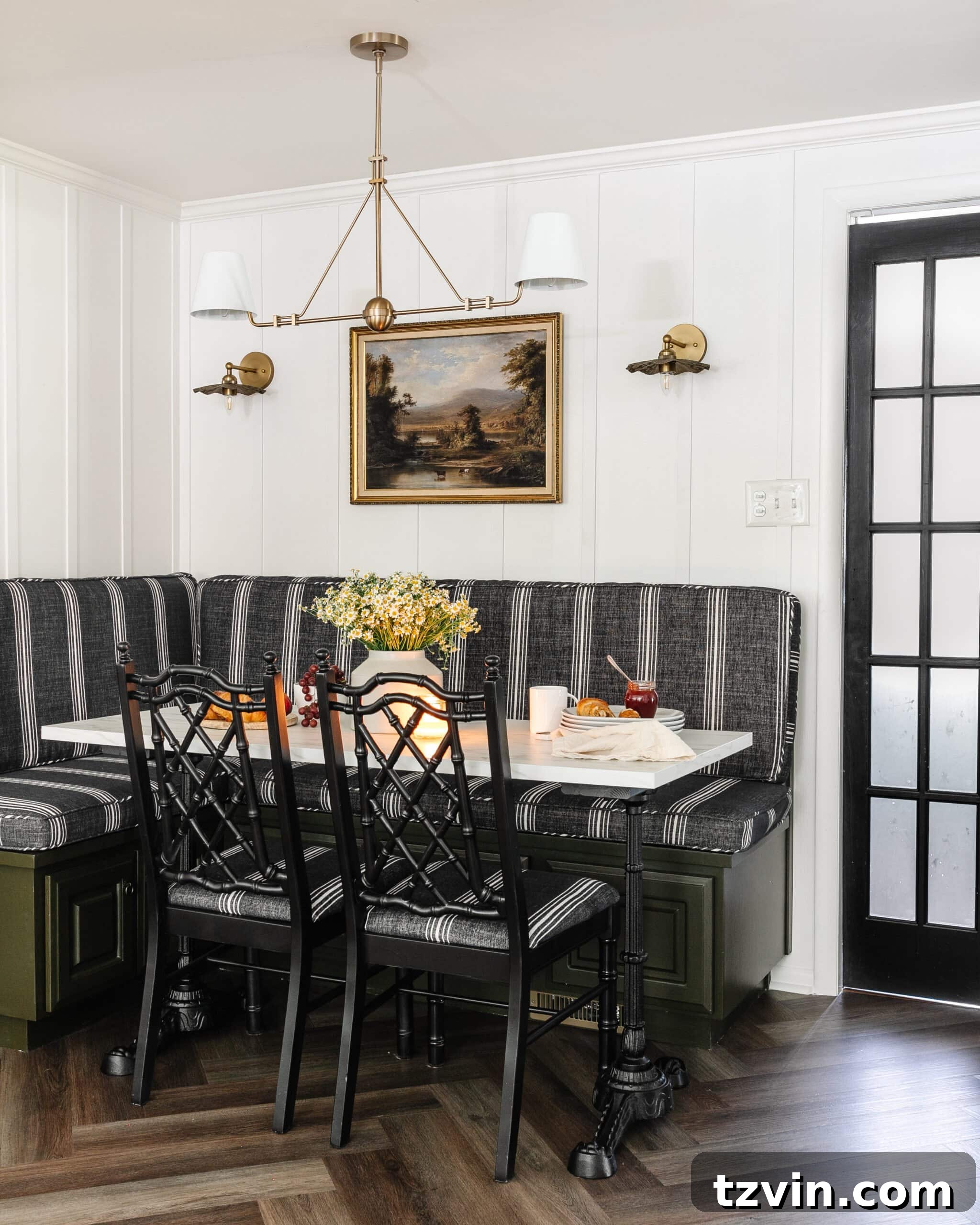 Kitchen and Nook Amazing Makeover 10 Breakfast nook banquette with stylish striped cushions, complemented by black bamboo chairs and a chic black French door, creating an inviting dining area.