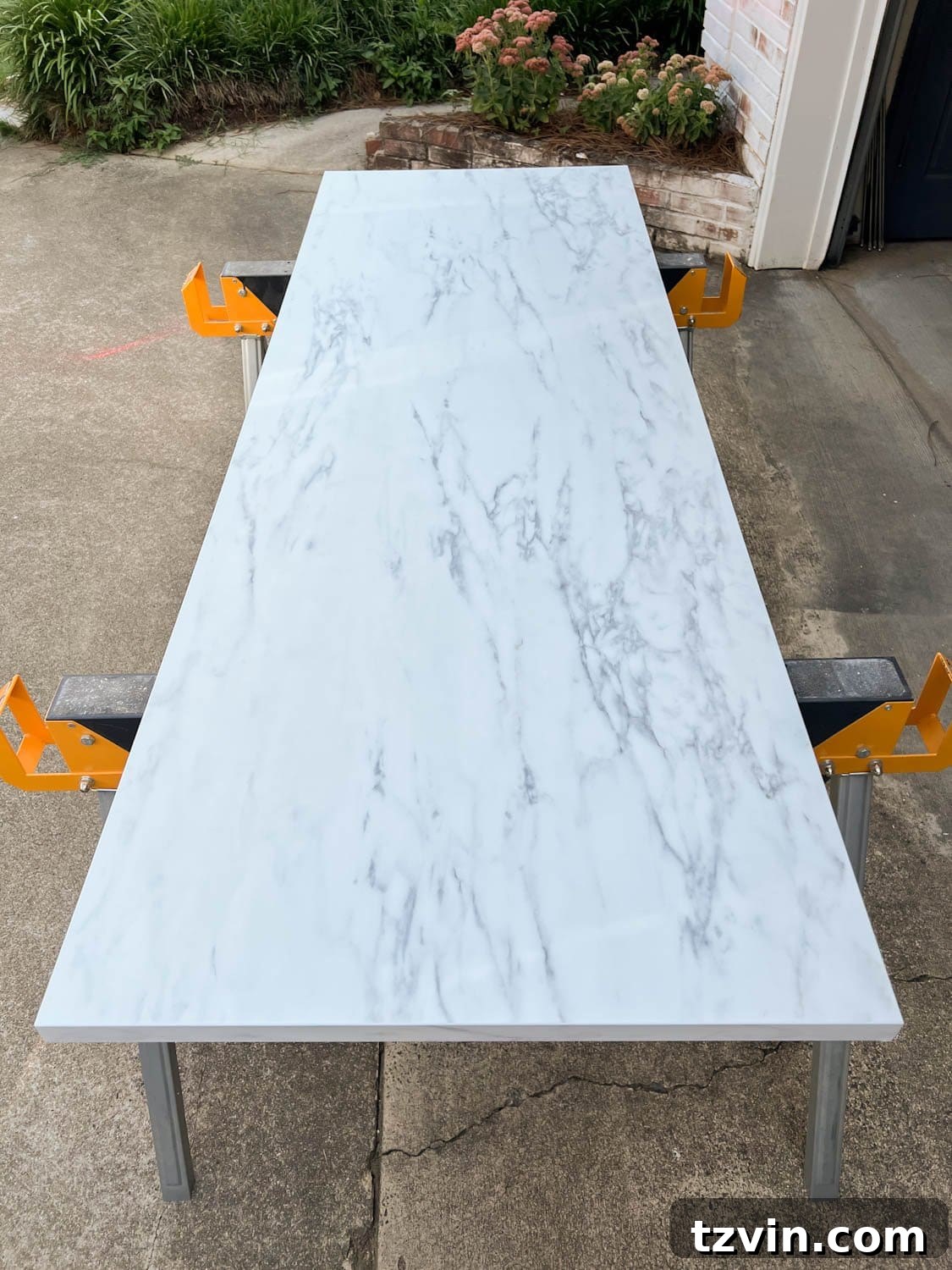 DIY Faux Marble Dining Table: Instant Luxury in Under an Hour 4 laminate faux marble countertop on saw horses, marked for cutting