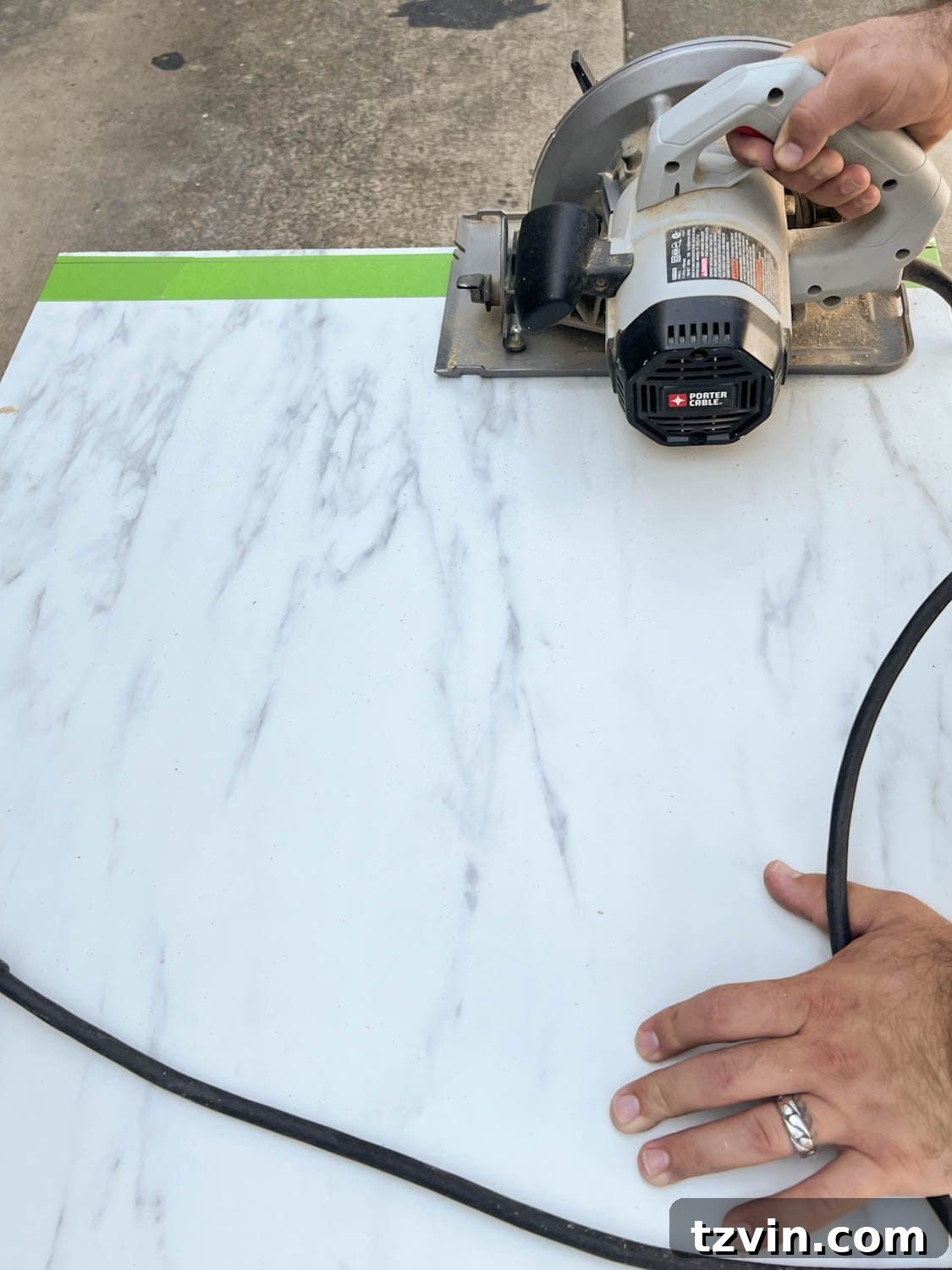 DIY Faux Marble Dining Table: Instant Luxury in Under an Hour 7 cutting laminate faux marble countertop with a circular saw, guided by masking tape for a clean finish