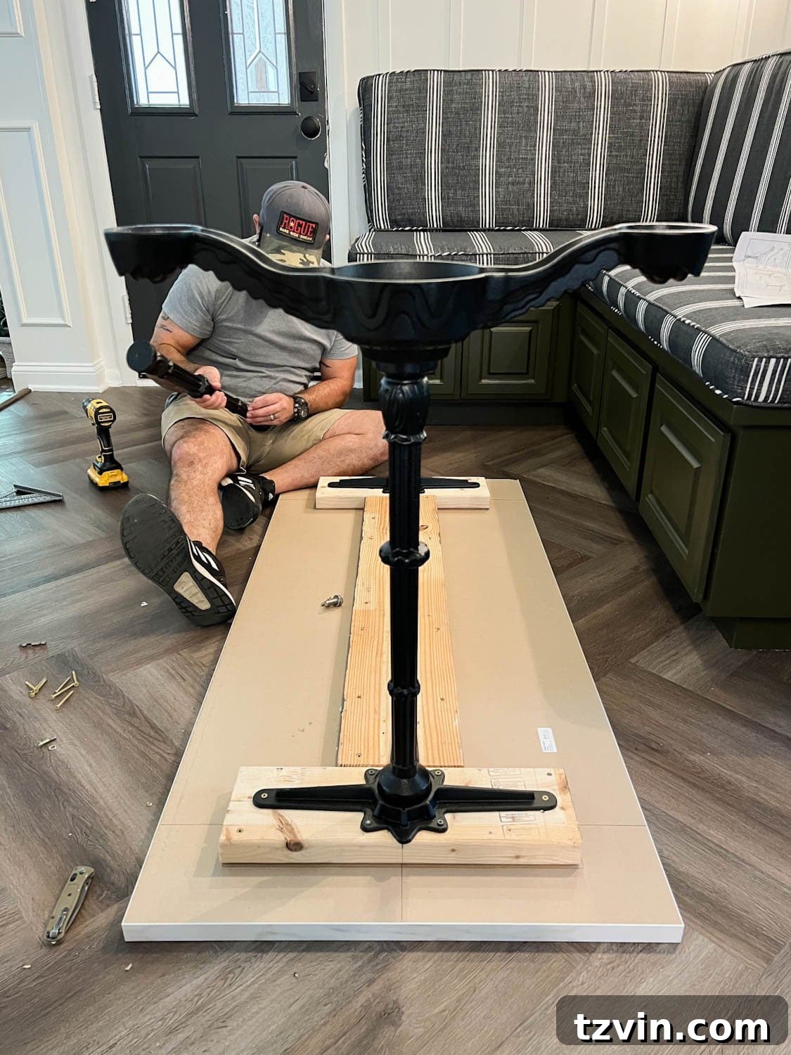 DIY Faux Marble Dining Table: Instant Luxury in Under an Hour 8 attaching 2x6 boards and cast iron pedestal legs underneath a countertop to make a faux marble dining table, showing the height addition