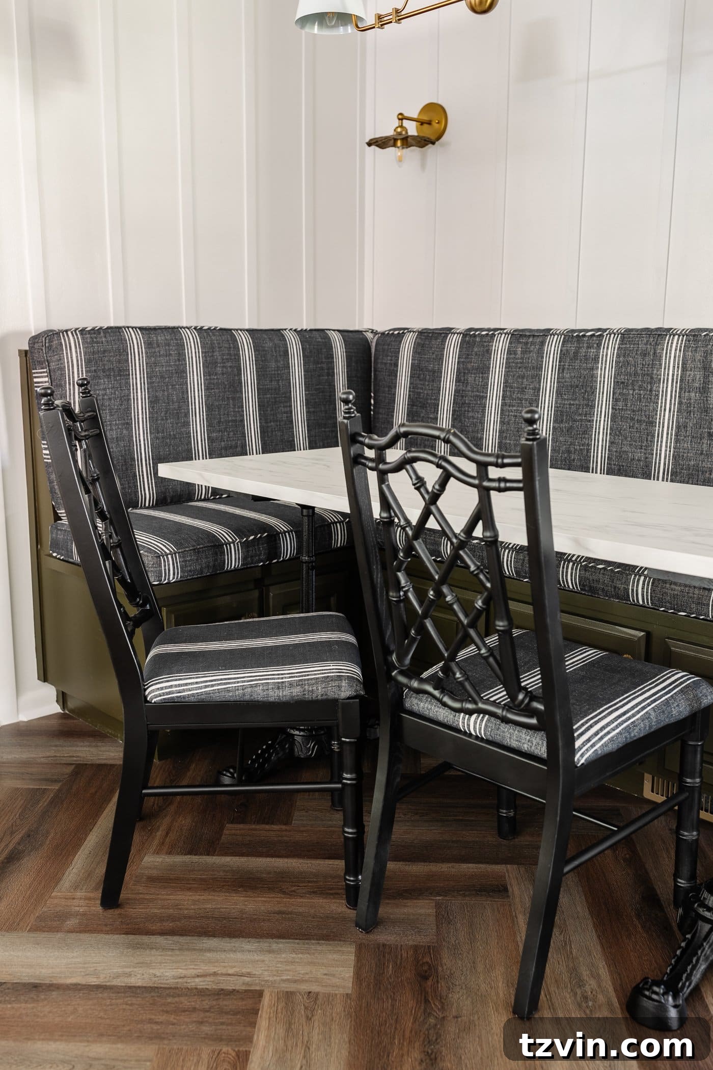 Revitalize Your Dining Chairs Seat Reupholstery and Faux Bamboo Transformation 11 black bamboo chairs with striped upholstered seats in a breakfast nook with olive green banquette bench