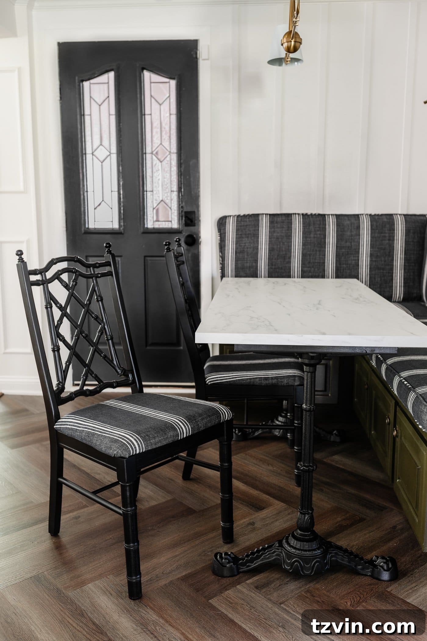 Revitalize Your Dining Chairs Seat Reupholstery and Faux Bamboo Transformation 13 black bamboo chairs with striped upholstered seats in a breakfast nook with olive green banquette bench