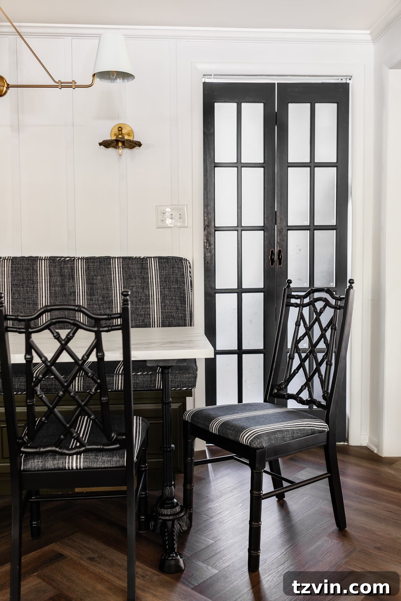 Revitalize Your Dining Chairs Seat Reupholstery and Faux Bamboo Transformation 14 black bamboo chairs with striped upholstered seats in a breakfast nook with olive green banquette bench